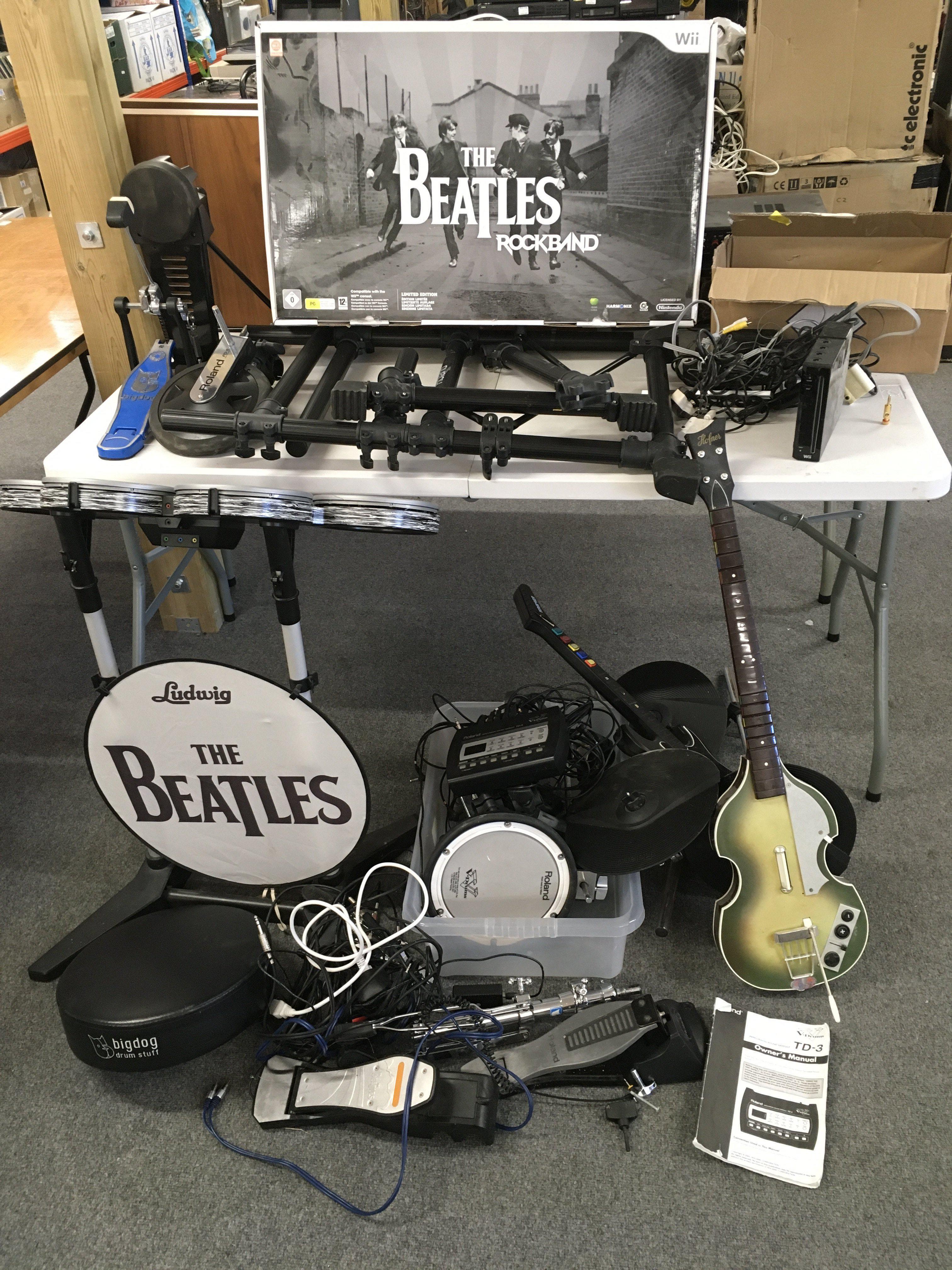 A collection of Roland V Drums and Wii Beatles Rockband items.