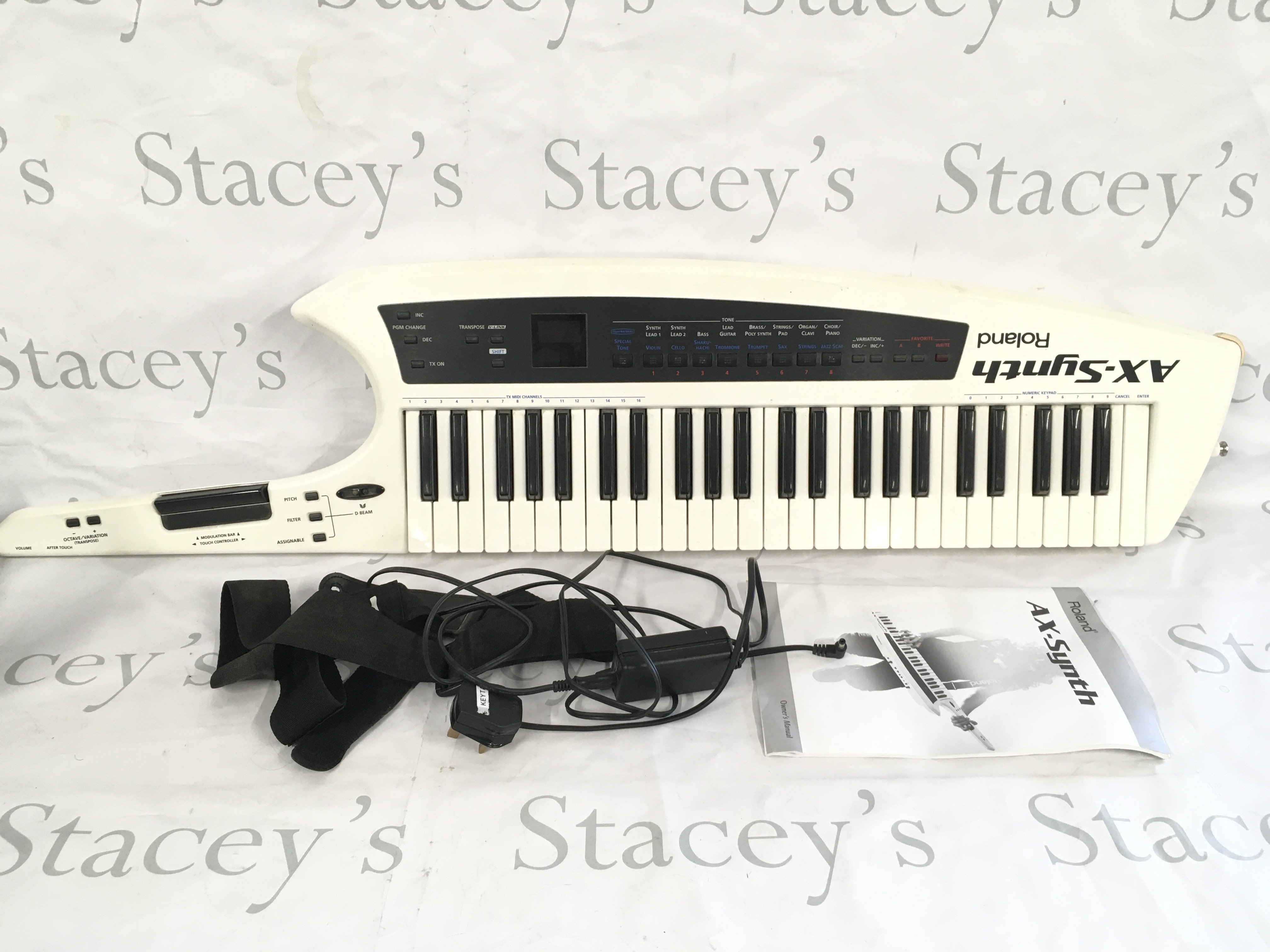 A Roland AX Synth Keytar with carry case, manual, power lead and strap.