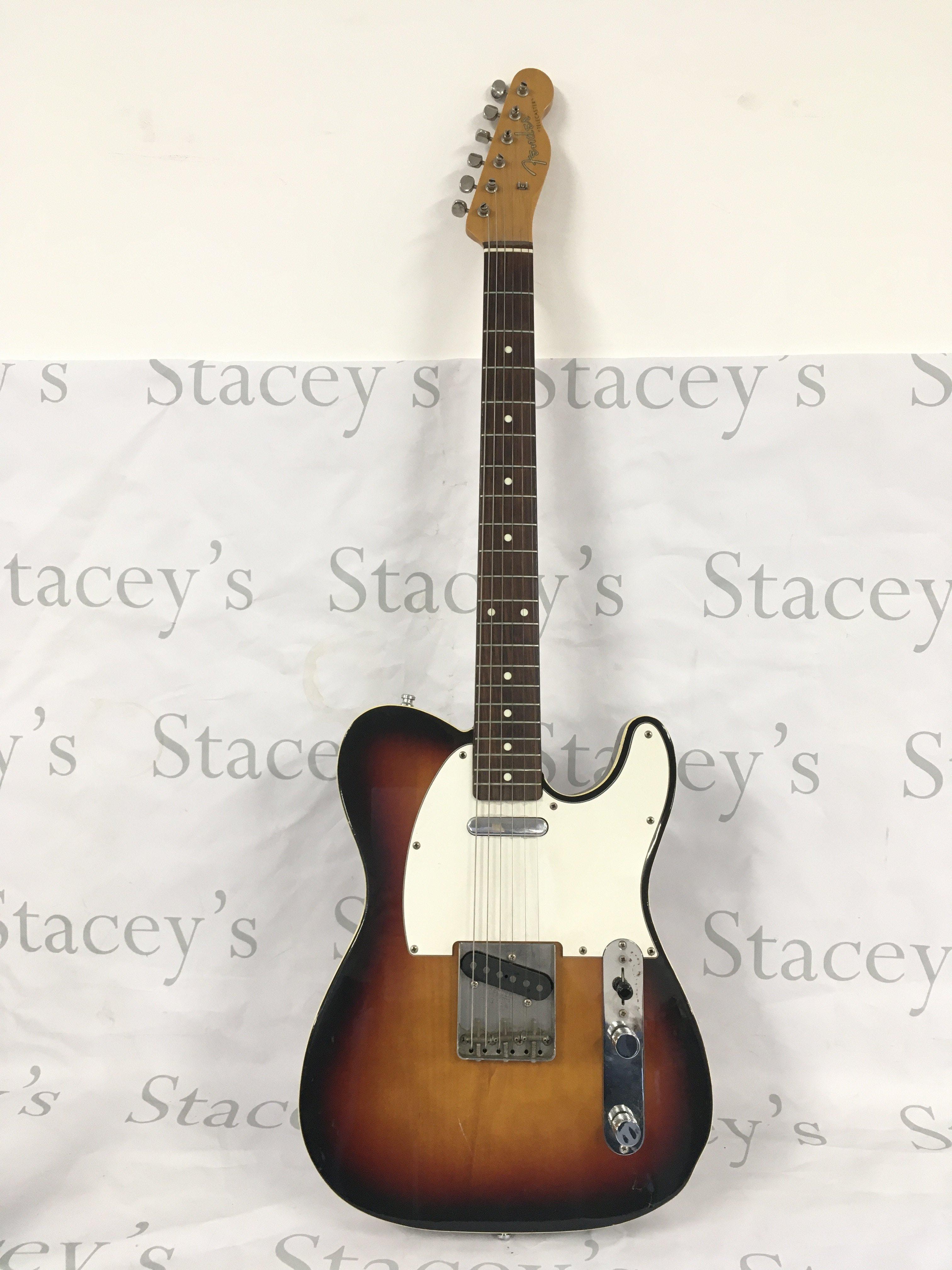 A Japanese Fender Telecaster electric guitar with a Fender branded hard carry case.