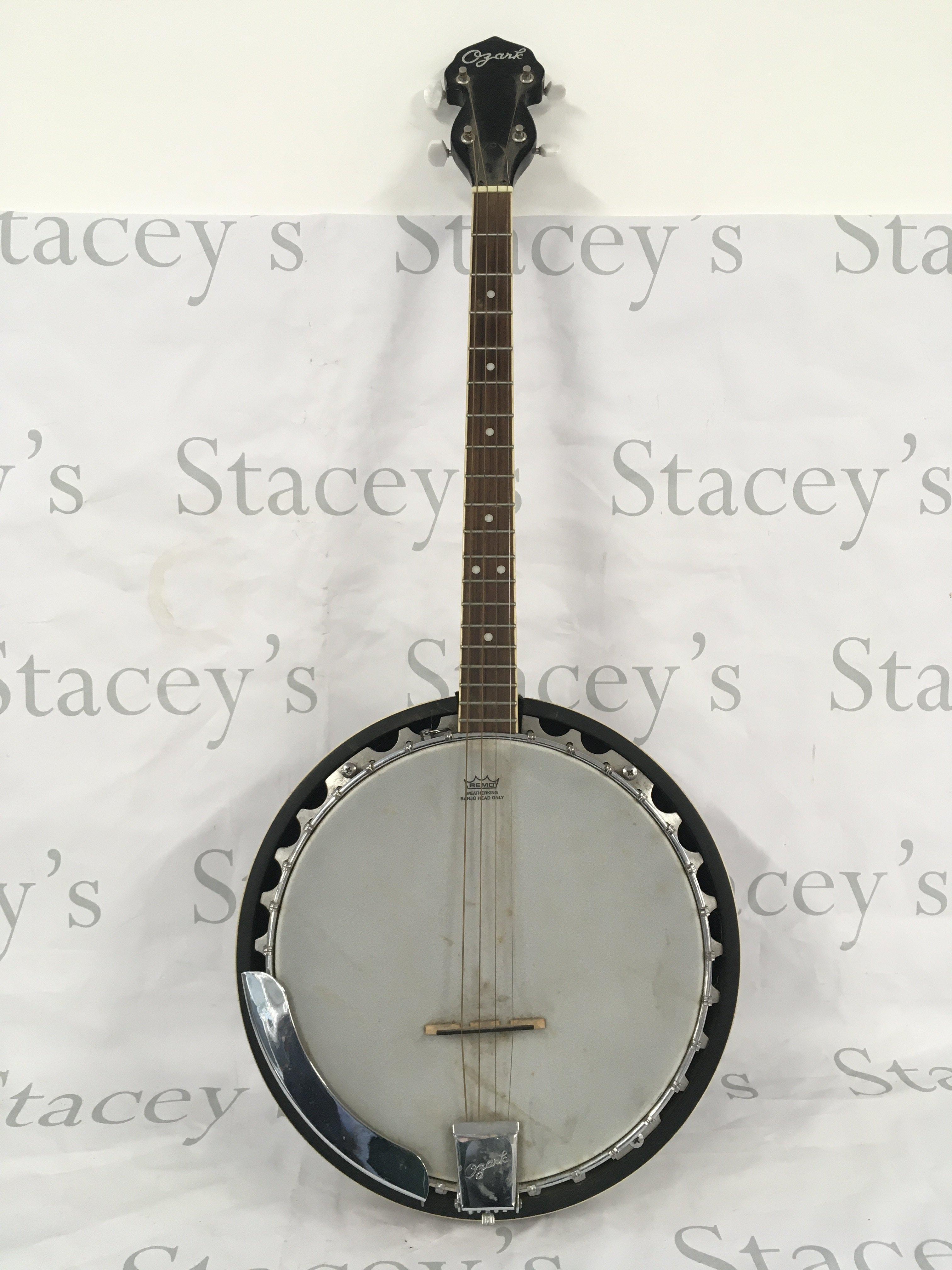 An Ozark four string banjo and original soft carry case.