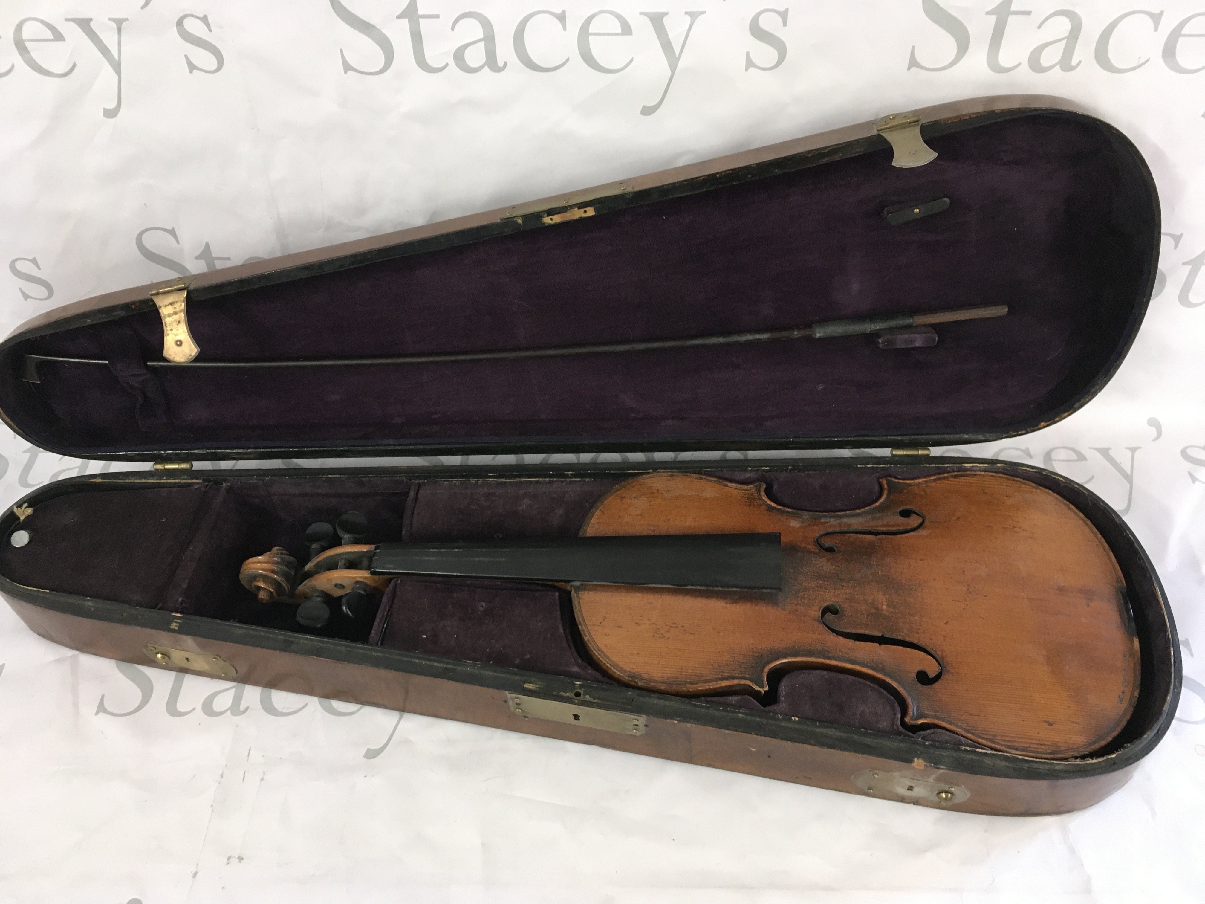 A cased violin marked Stradivarius.