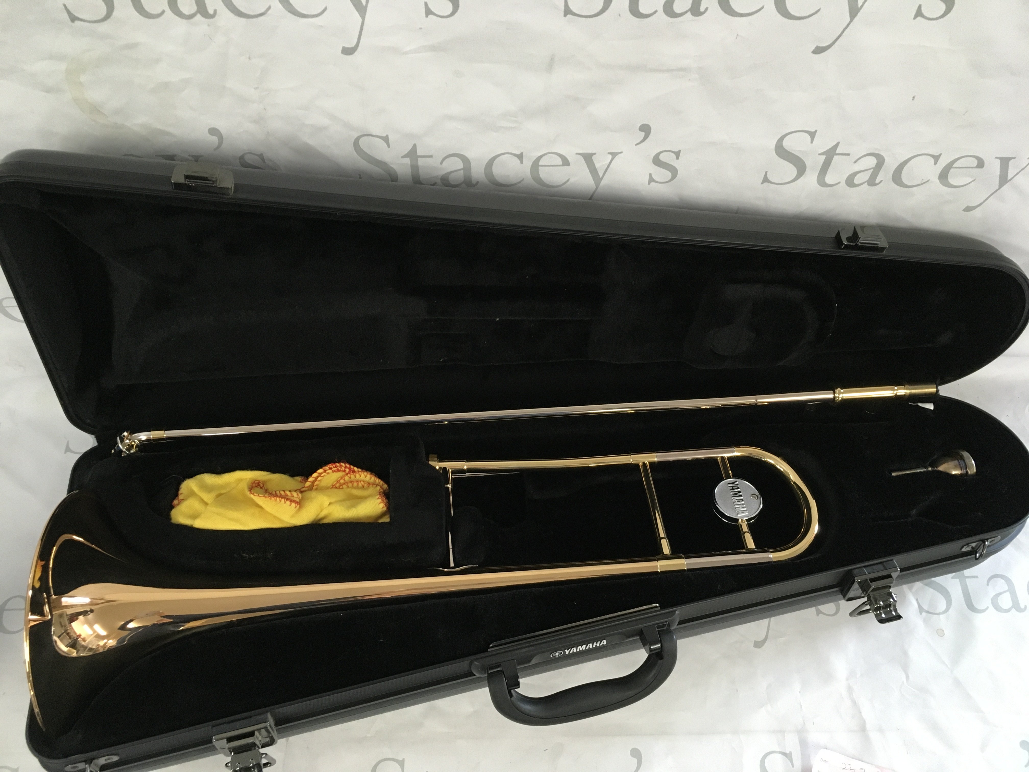 A cased Yamaha trombone.