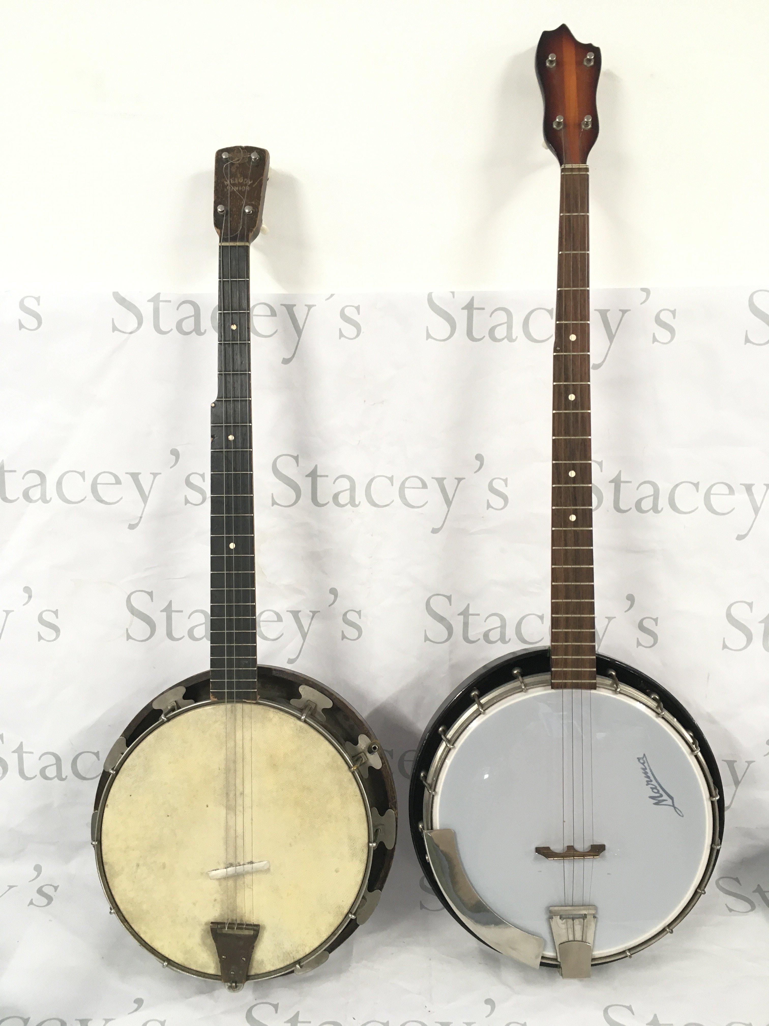 Two banjos with soft carry cases and a soprano ukulele with a hard carry case (3).