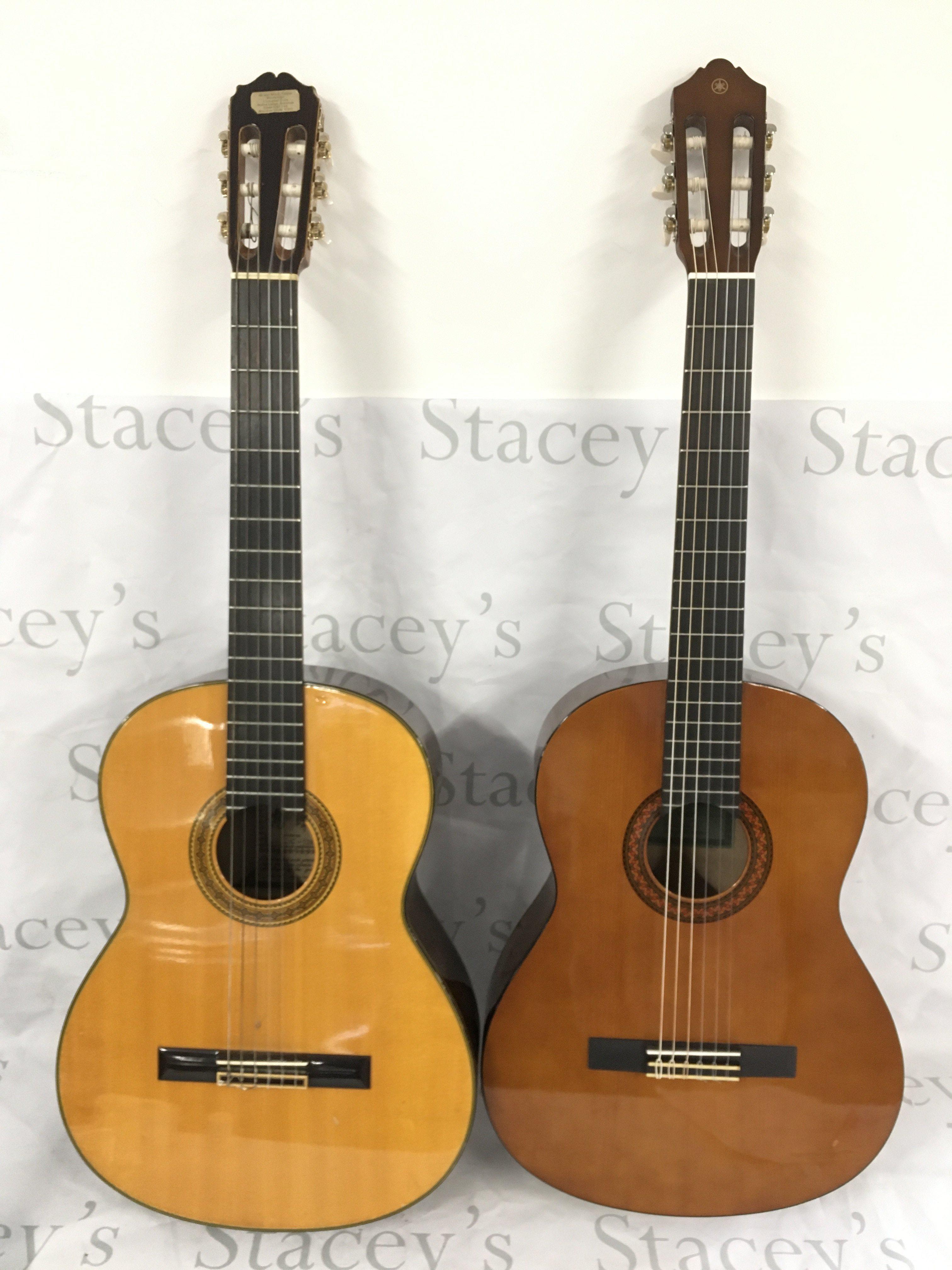 Two classical guitars comprising a Takamine C-128 and a Yamaha C40, both with hard carry cases. Please see image of discolouration to the reverse of the Takamine.