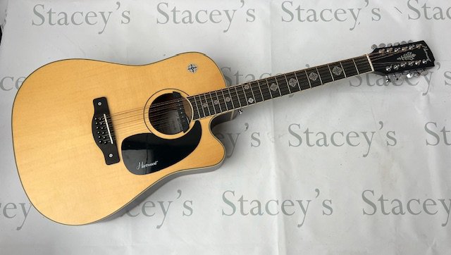 A Hartwood Villanelle 12" string Acoustic Guitar with pickup and cutaway and Celtic cross fret markers. As new in original box. Click Here to Register to bid