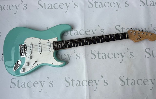 A Squire Stratocaster by Fender in Ice Blue finish in good overall condition comes with Fender gig bag.