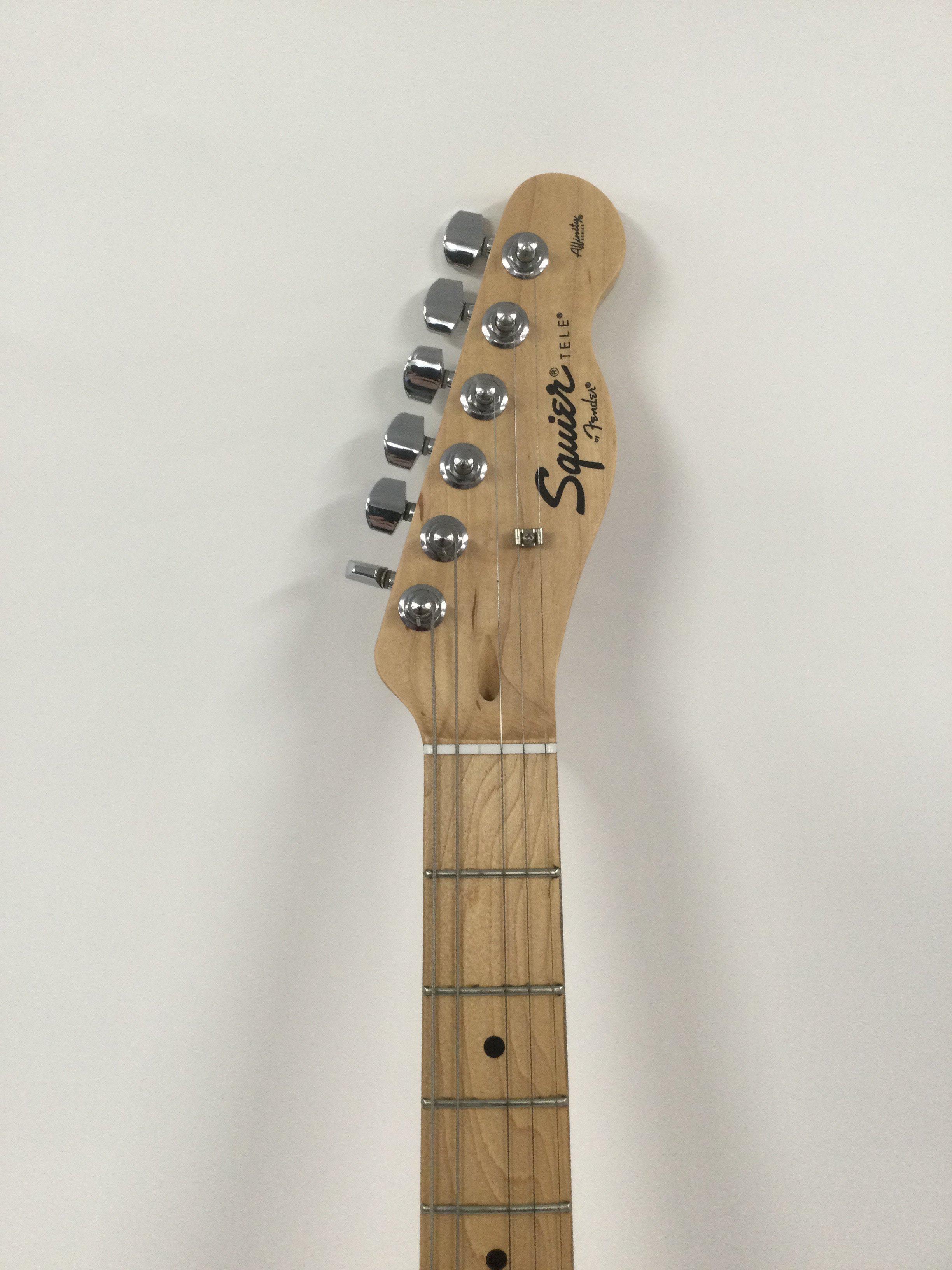 A Fender Squier Telecaster in red. Comes with a soft carry case.