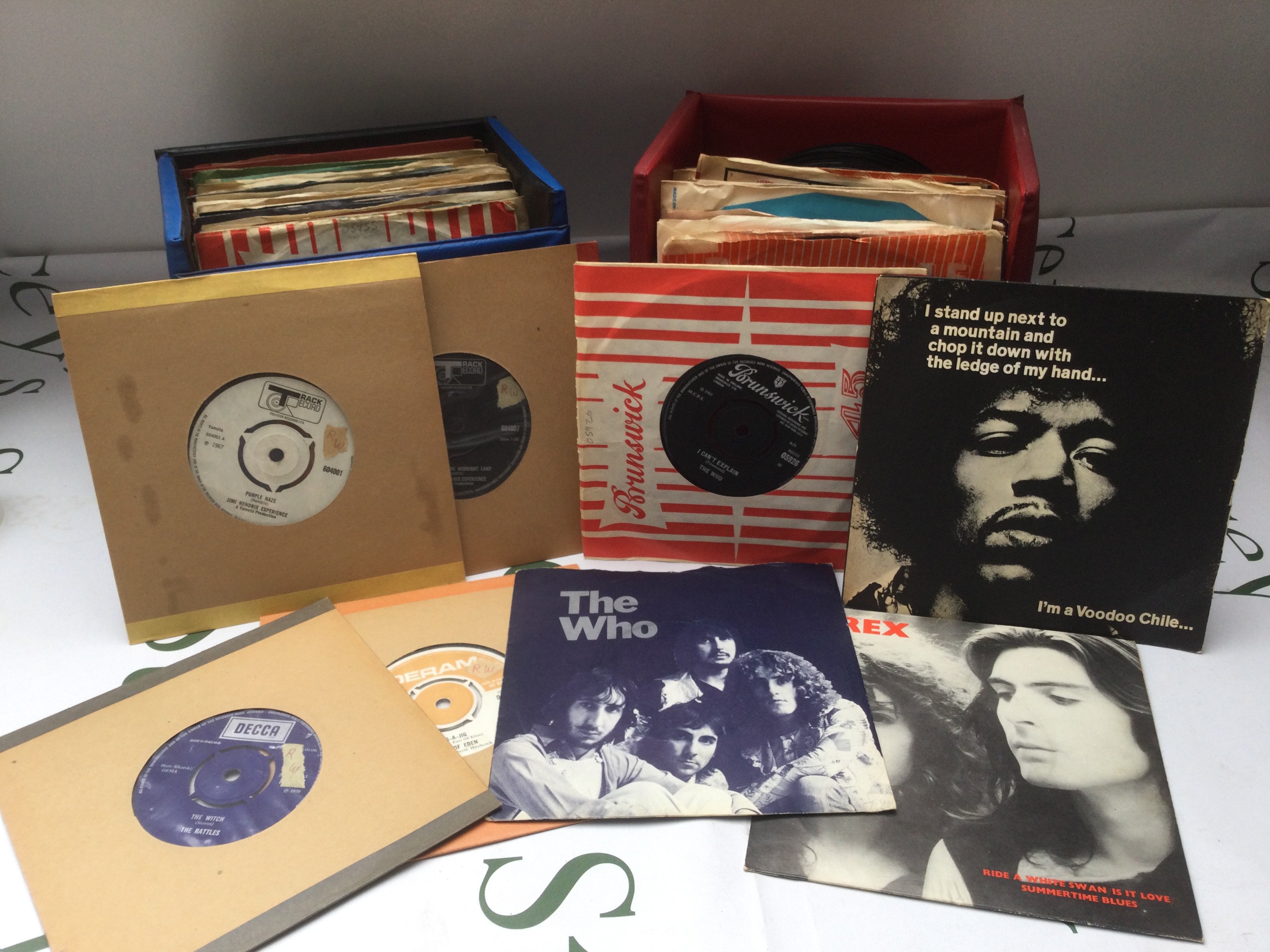 Three record cases of 7" singles by various artists including Jimi Hendrix, The Who, Rolling Stones and many more.