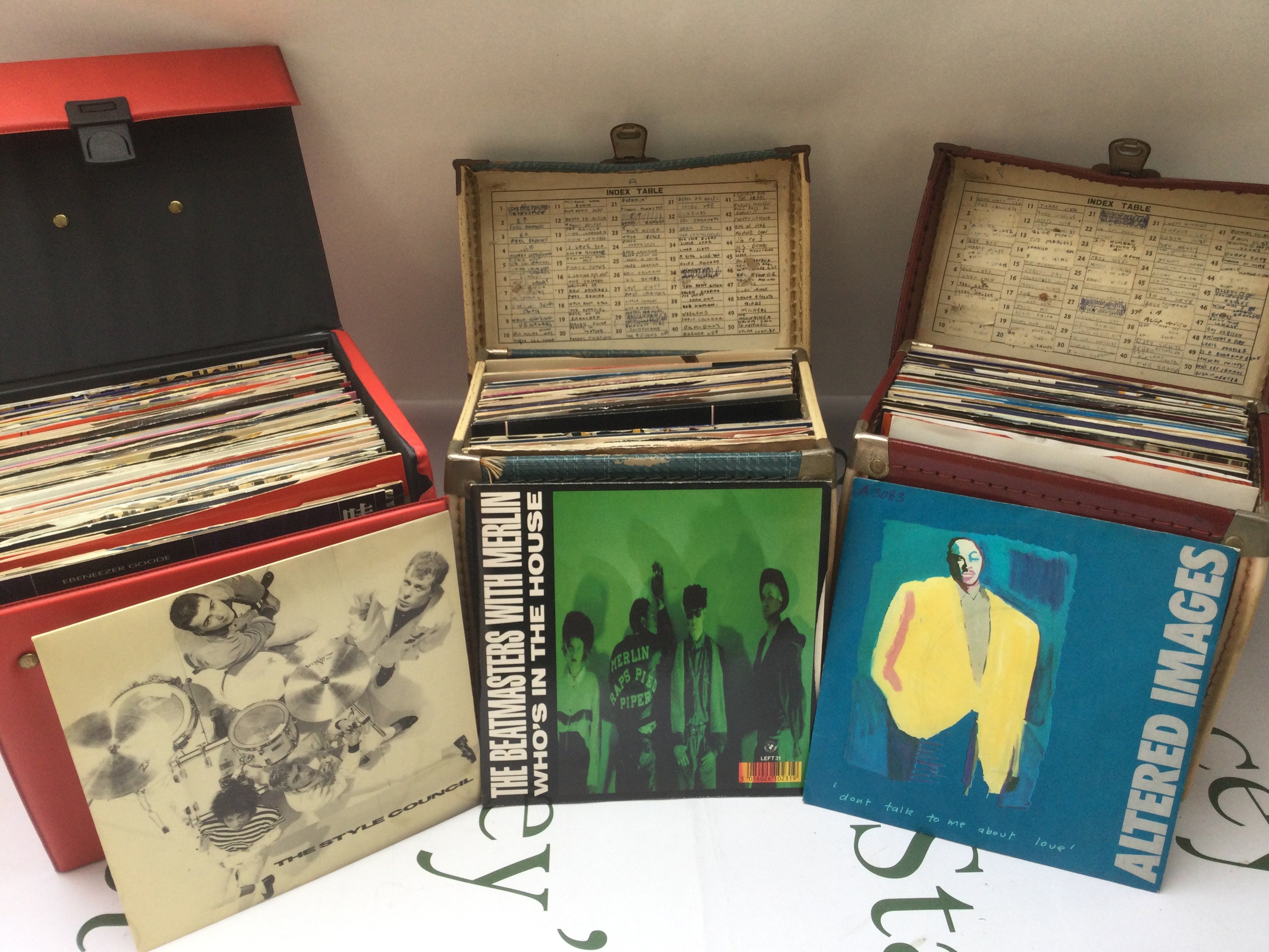 Three record cases of 7" singles comprising mainly 1980s and 90s artists.