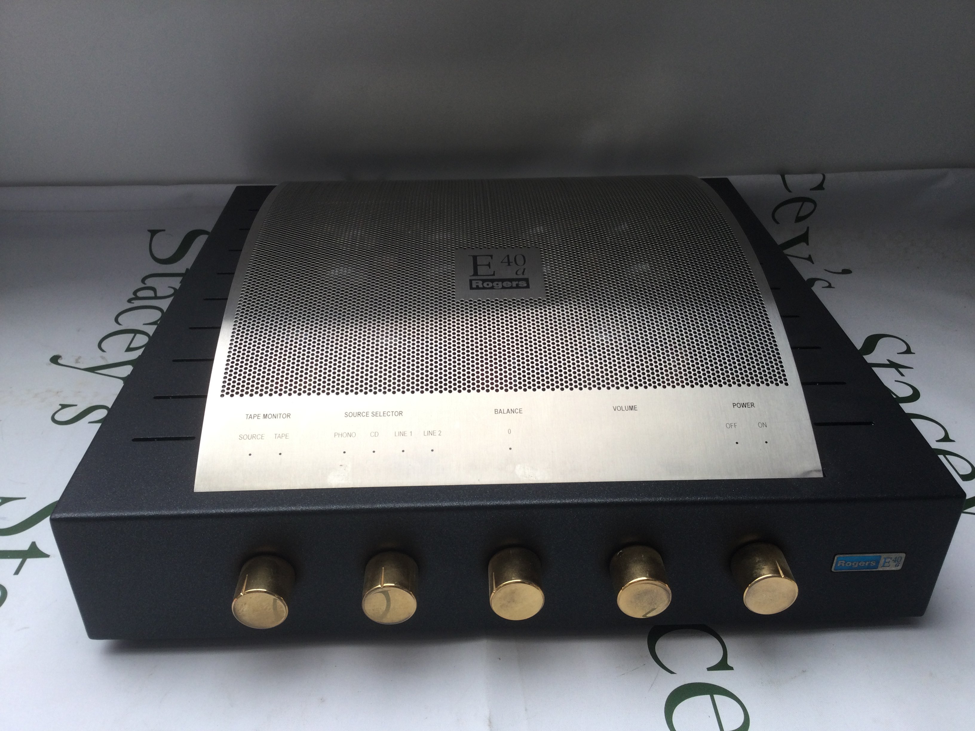 A boxed Rogers E40-A integrated valve amplifier with manuals and cables.
