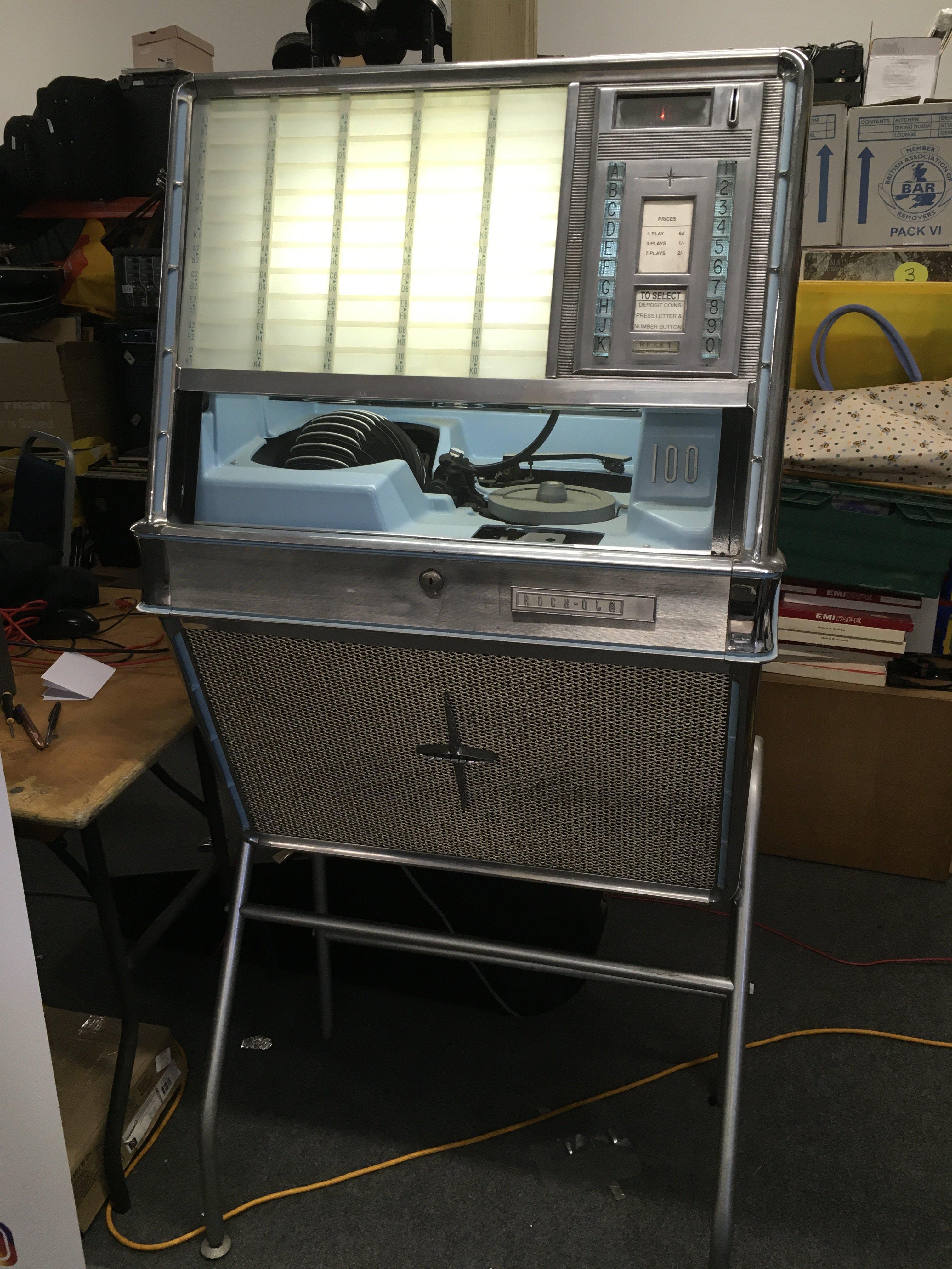 A Rock Ola 430 jukebox in need of restoration. Powers up, turntable spins but does not accept selection.