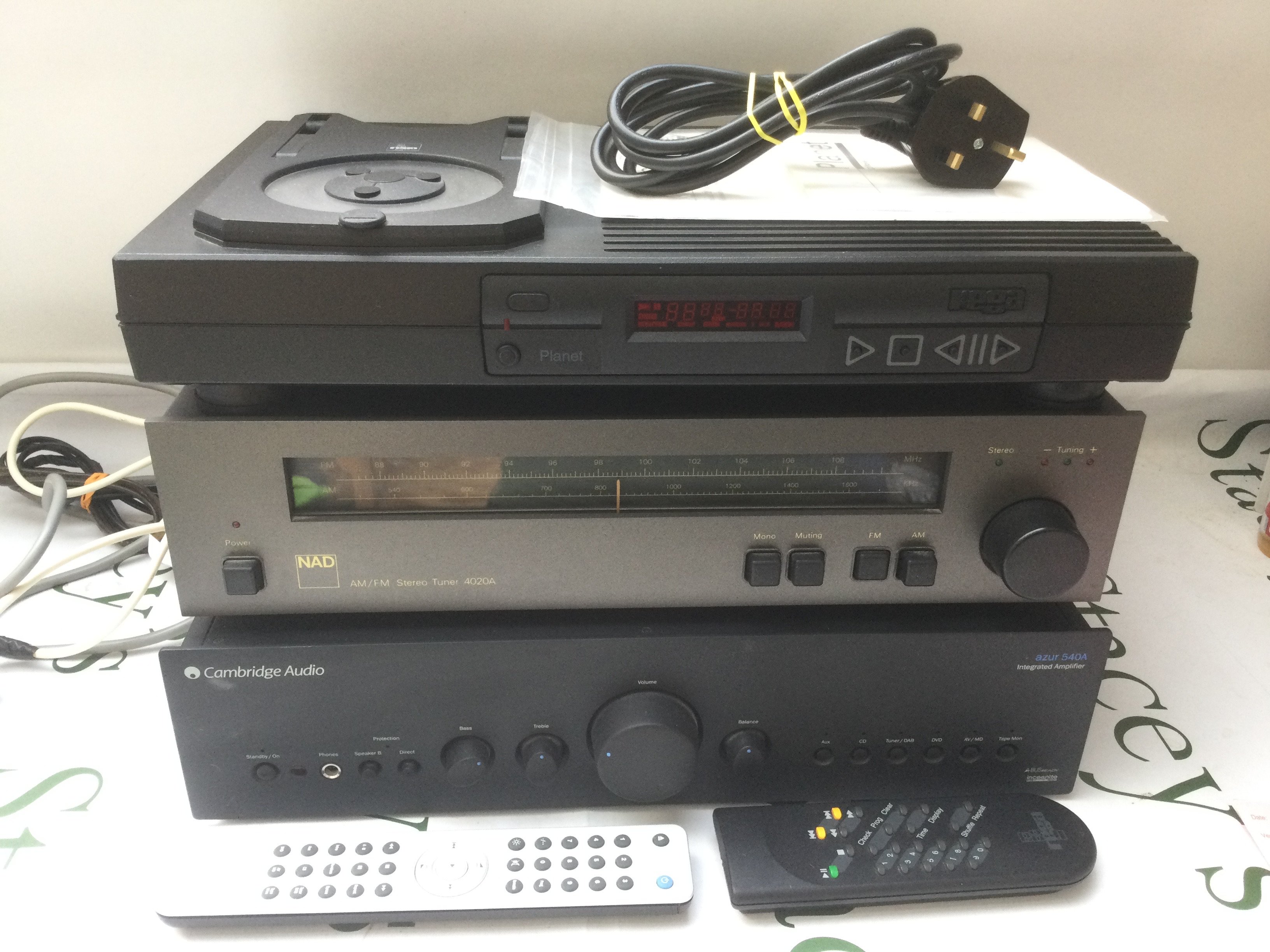 A collection of good quality hi-fi equipment comprising a Rega Planet CD player, a Cambridge Audio Azur 540A amp, NAD 4020A tuner and a pair of boxed Mordaunt Short MS914 floorstanding speakers. Comes with a manual for the player and two remote controls.