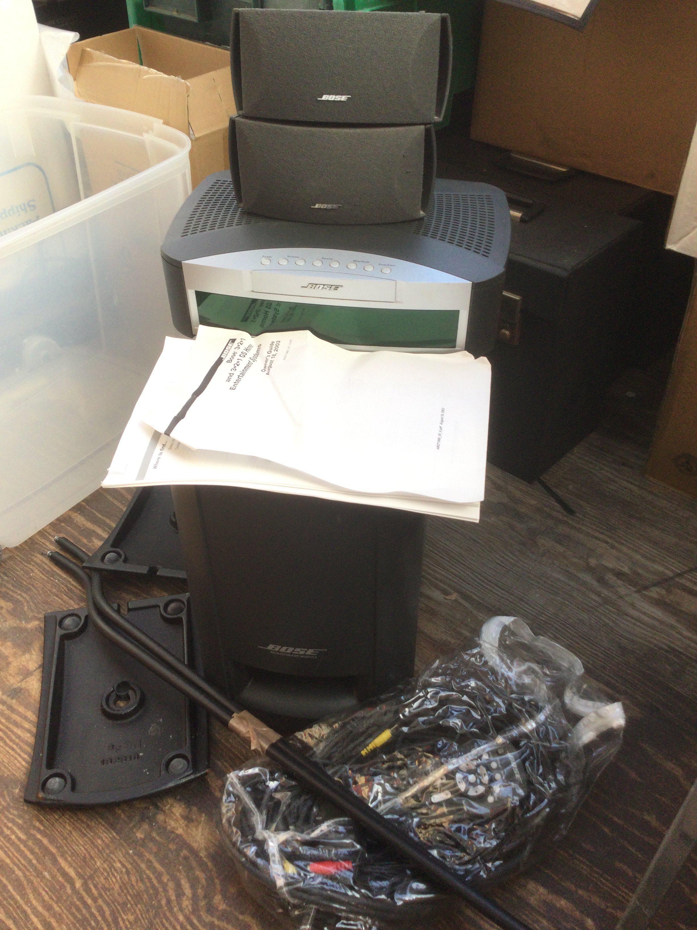 A Bose 3-2-1 home entertainment system with manual and remote control.