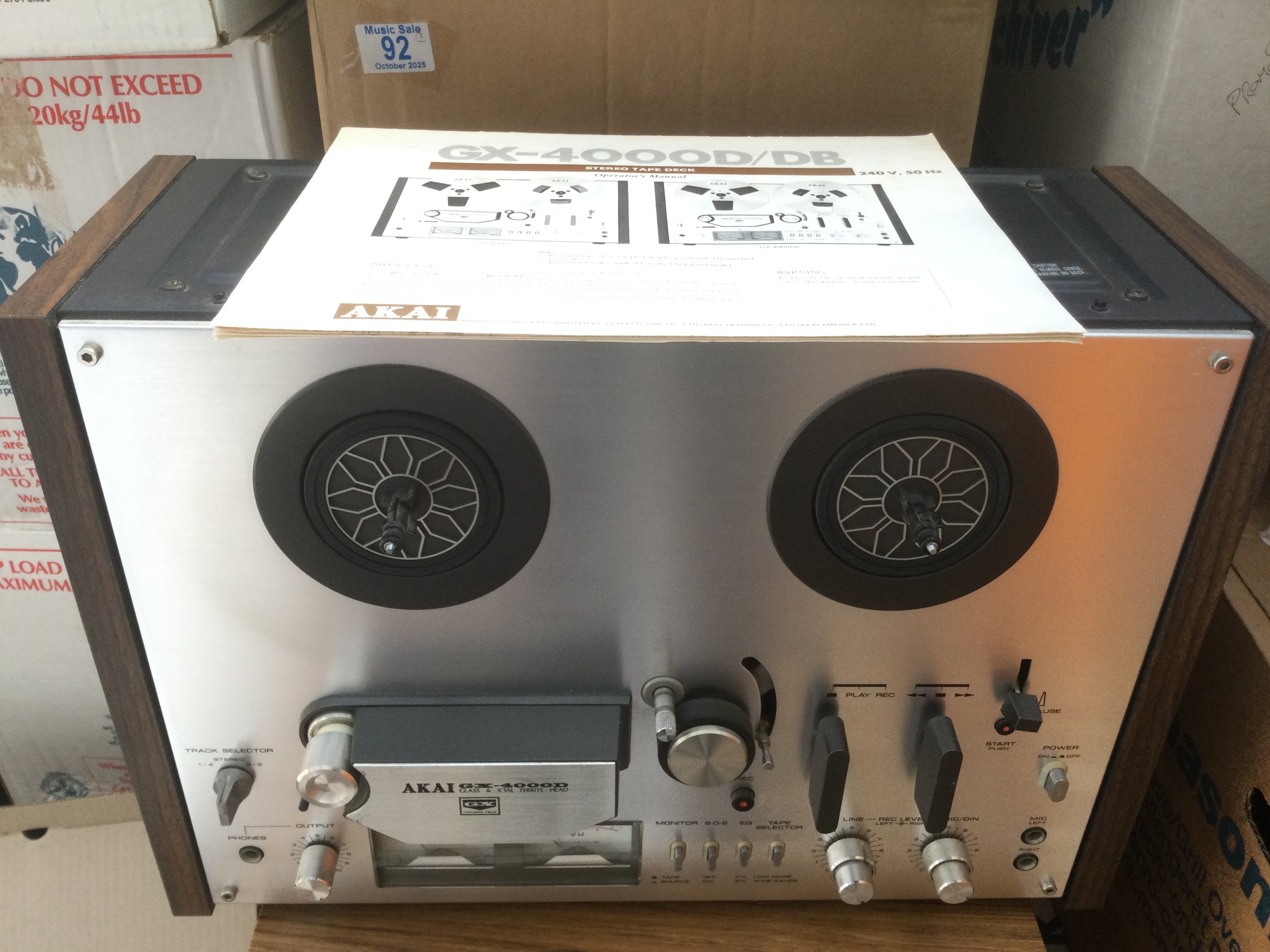 A boxed Akai GX4000D reel to reel player and a box of reels (2). Comes with manual.