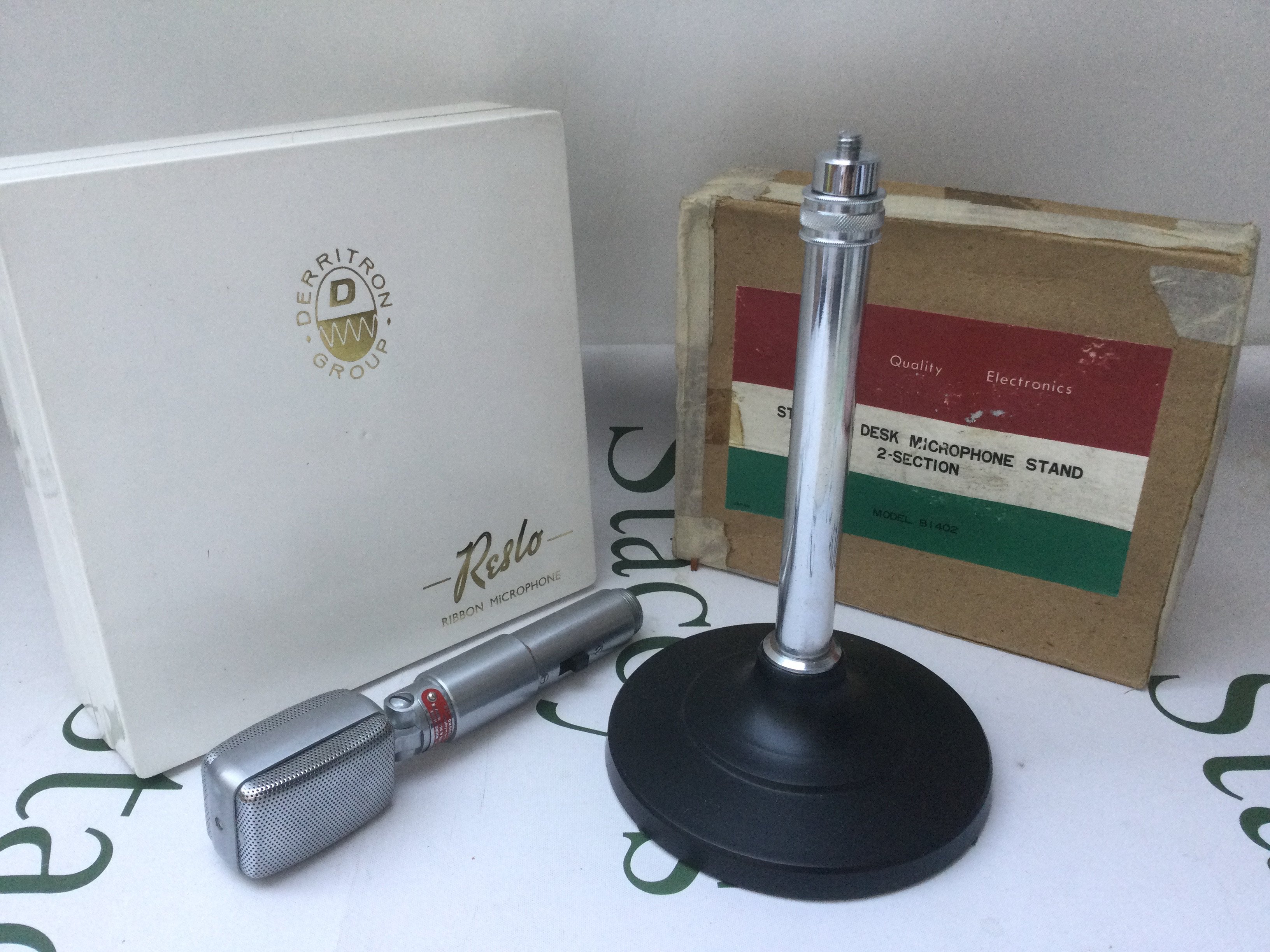 A boxed Reslosound RBH/TS ribbon microphone and stand, also boxed. Comes with instructions and lead.