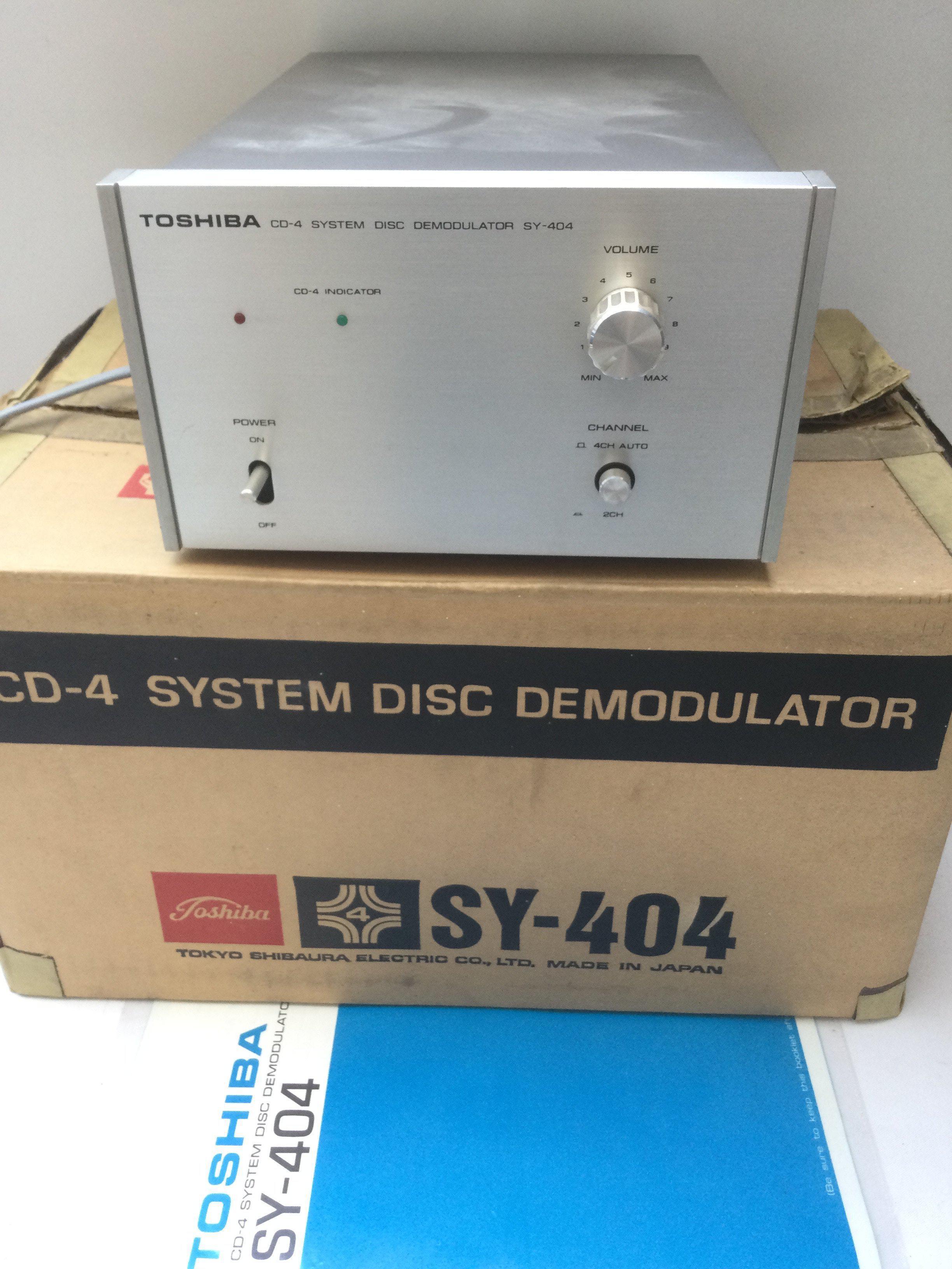 A boxed Toshiba SY-404 CD-4 system disc demodulator with manual.