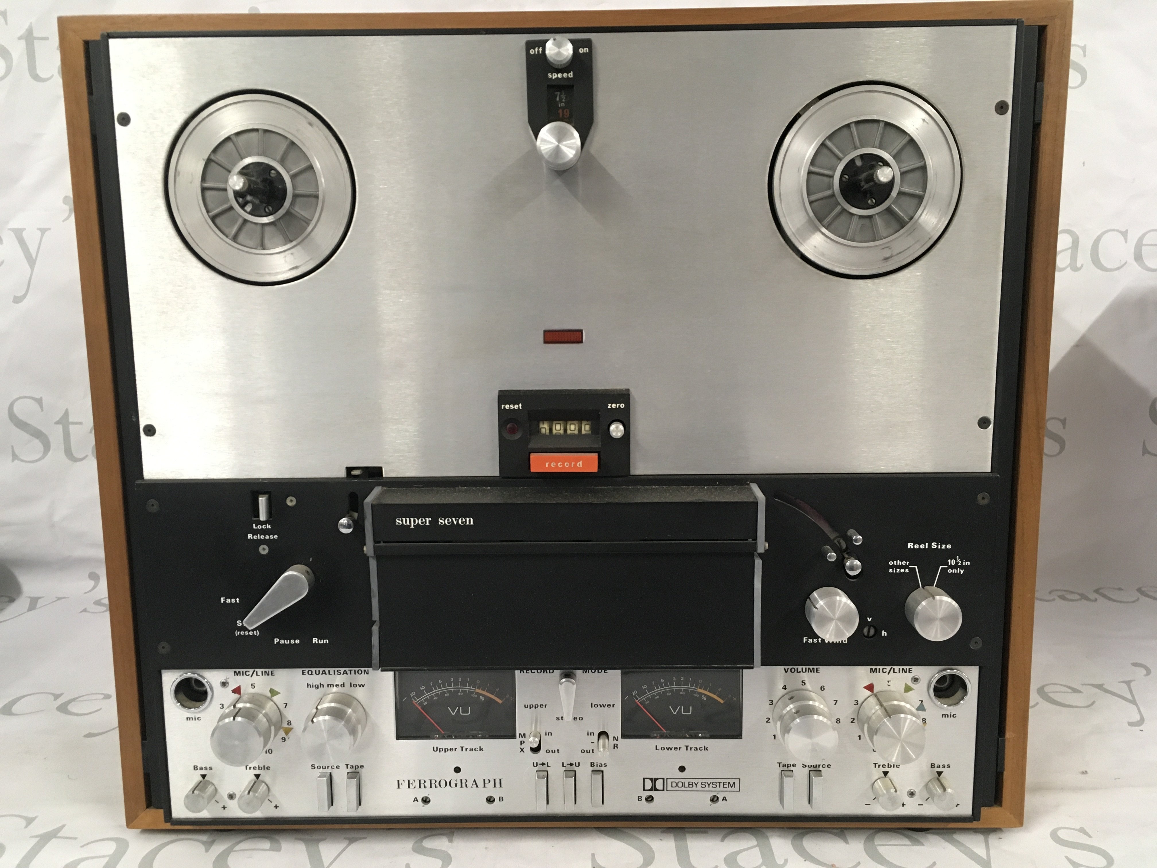 A circa 1970s Ferrograph Super Seven reel to reel player with handbooks and reels.