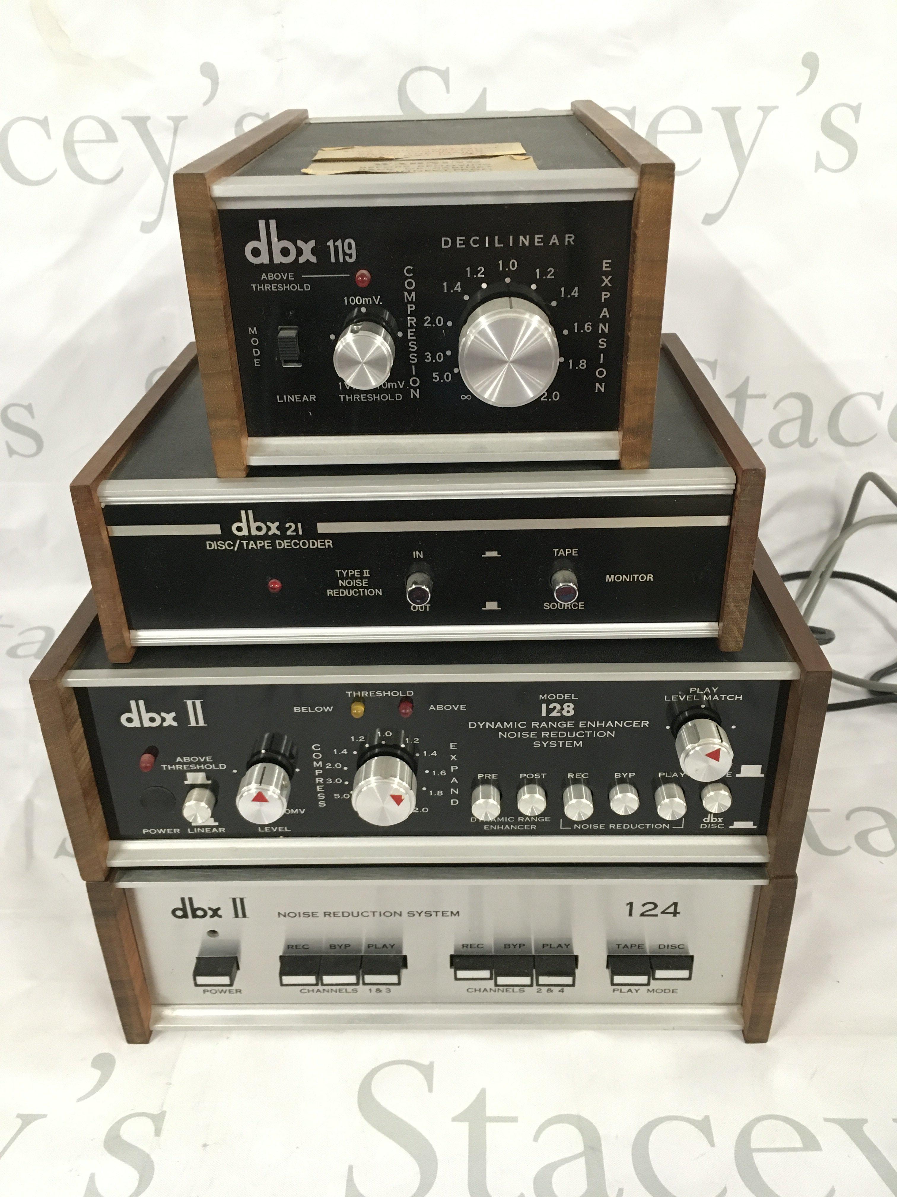 Four boxed DBX HiFi separates comprising a DBX 21 disc/tape decoder with manual, DBX 119 Decilinear Compression Expander Stereo Dynamic Range Enhancer, a DBX 124 Noise Reduction System and a DBX 128 Dynamic Range Enhancer.