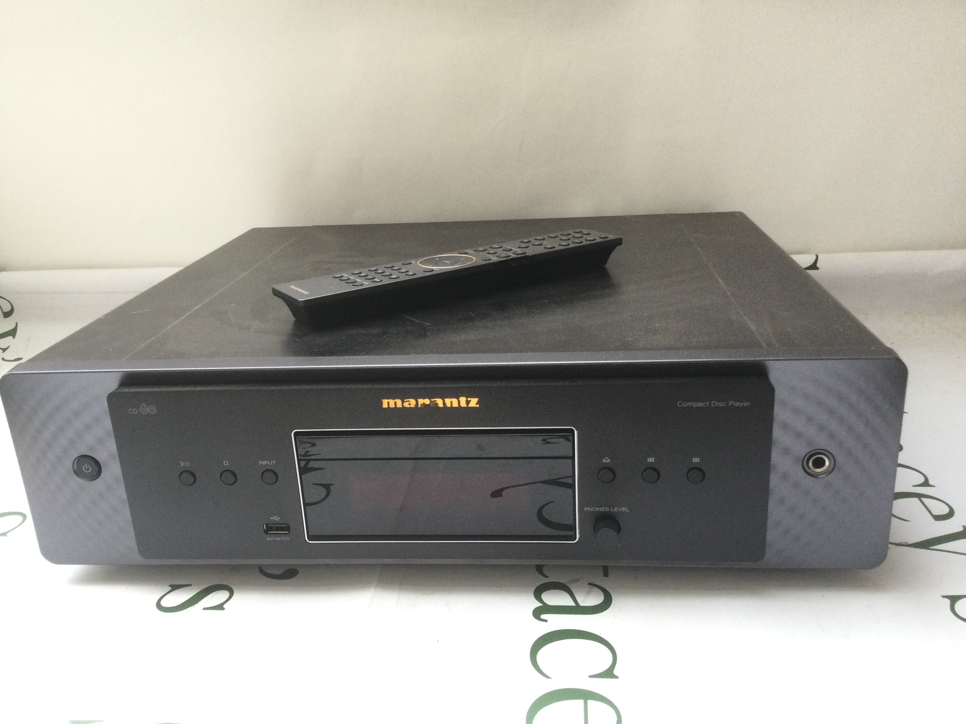 A Marantz CD60 CD player and remote control.