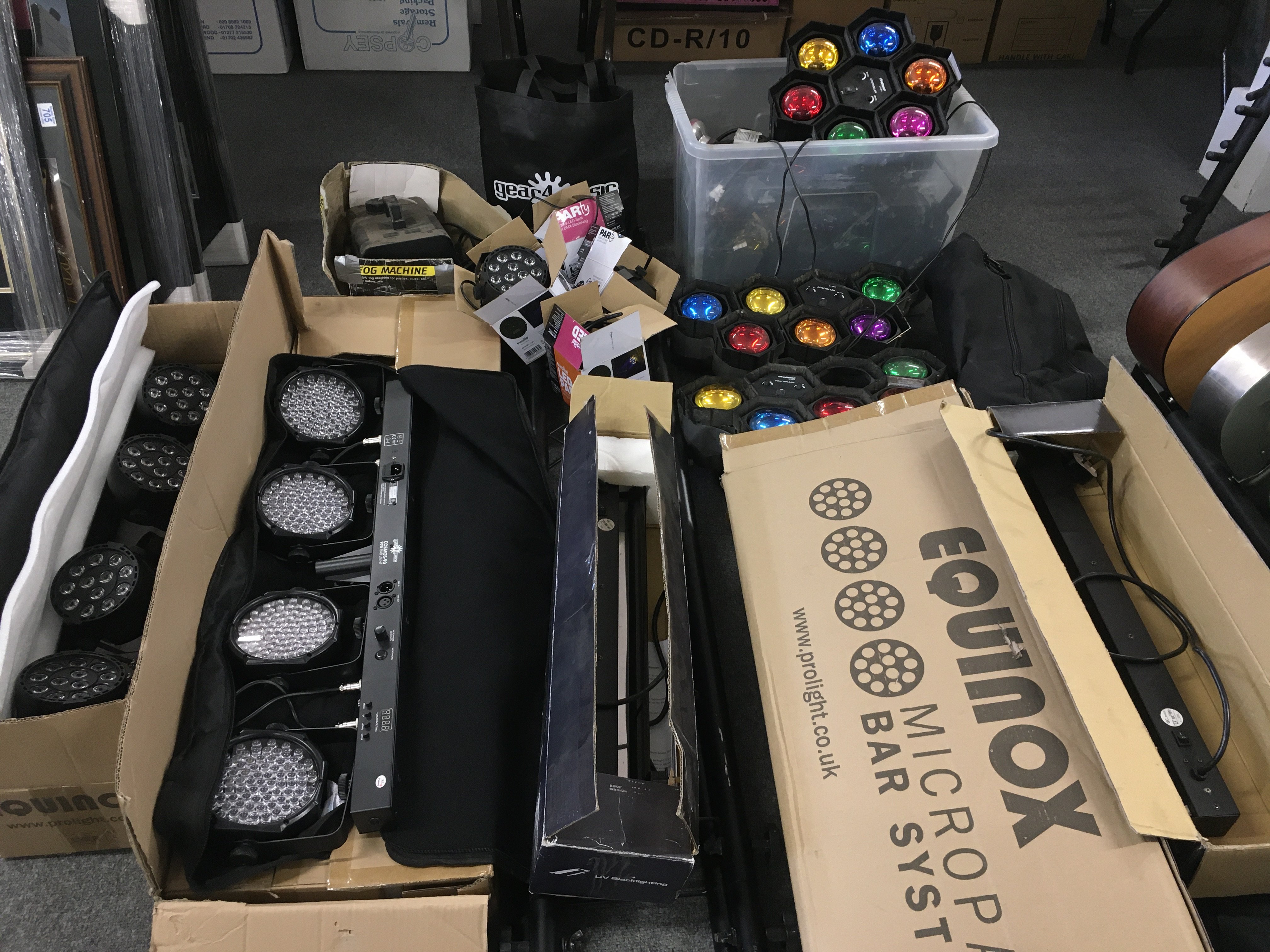 A collection of disco lighting equipment, fog machine, stands etc.