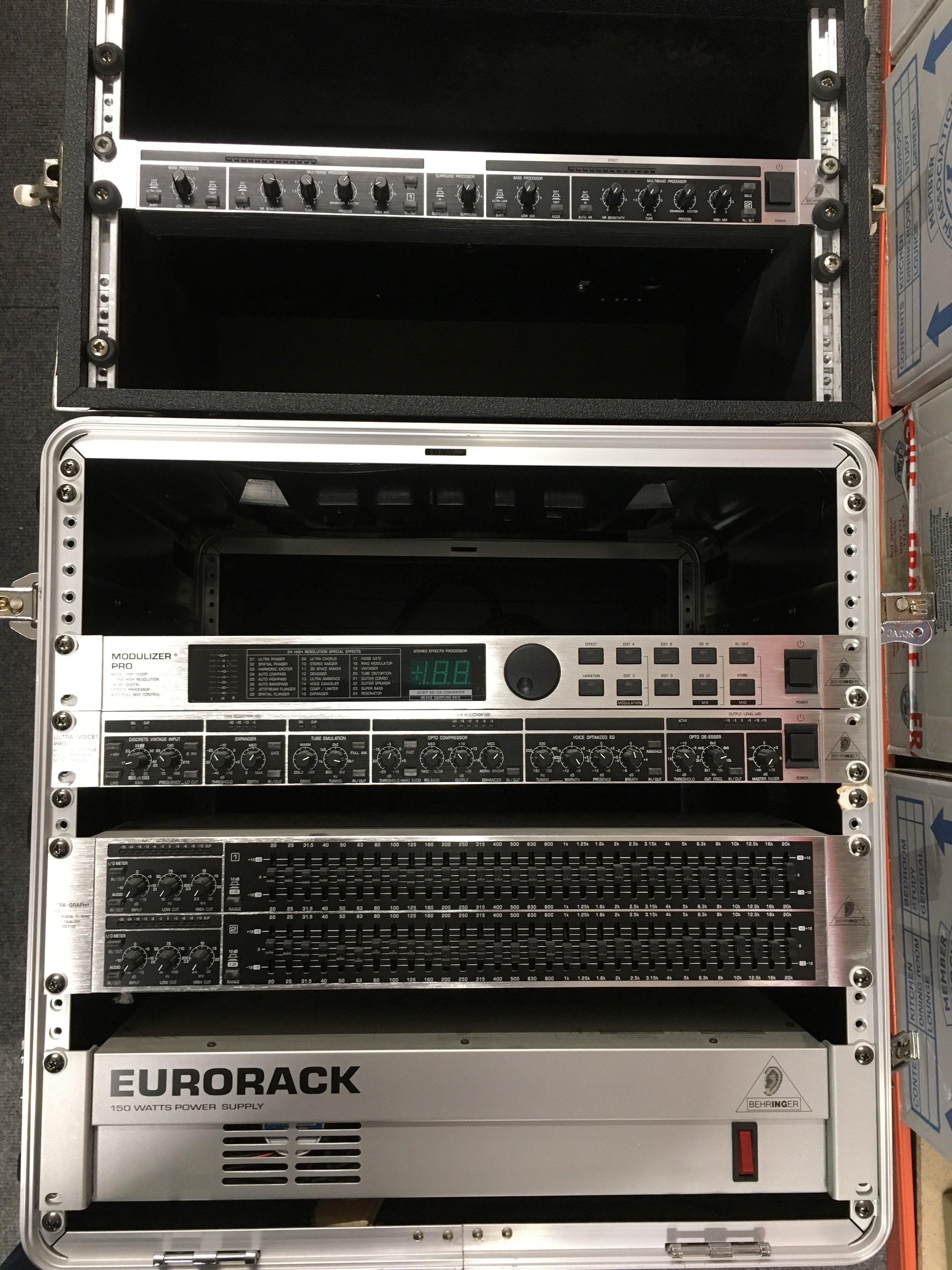 Three rack effects units and a Eurorack 150w power supply housed in hard shell cases.