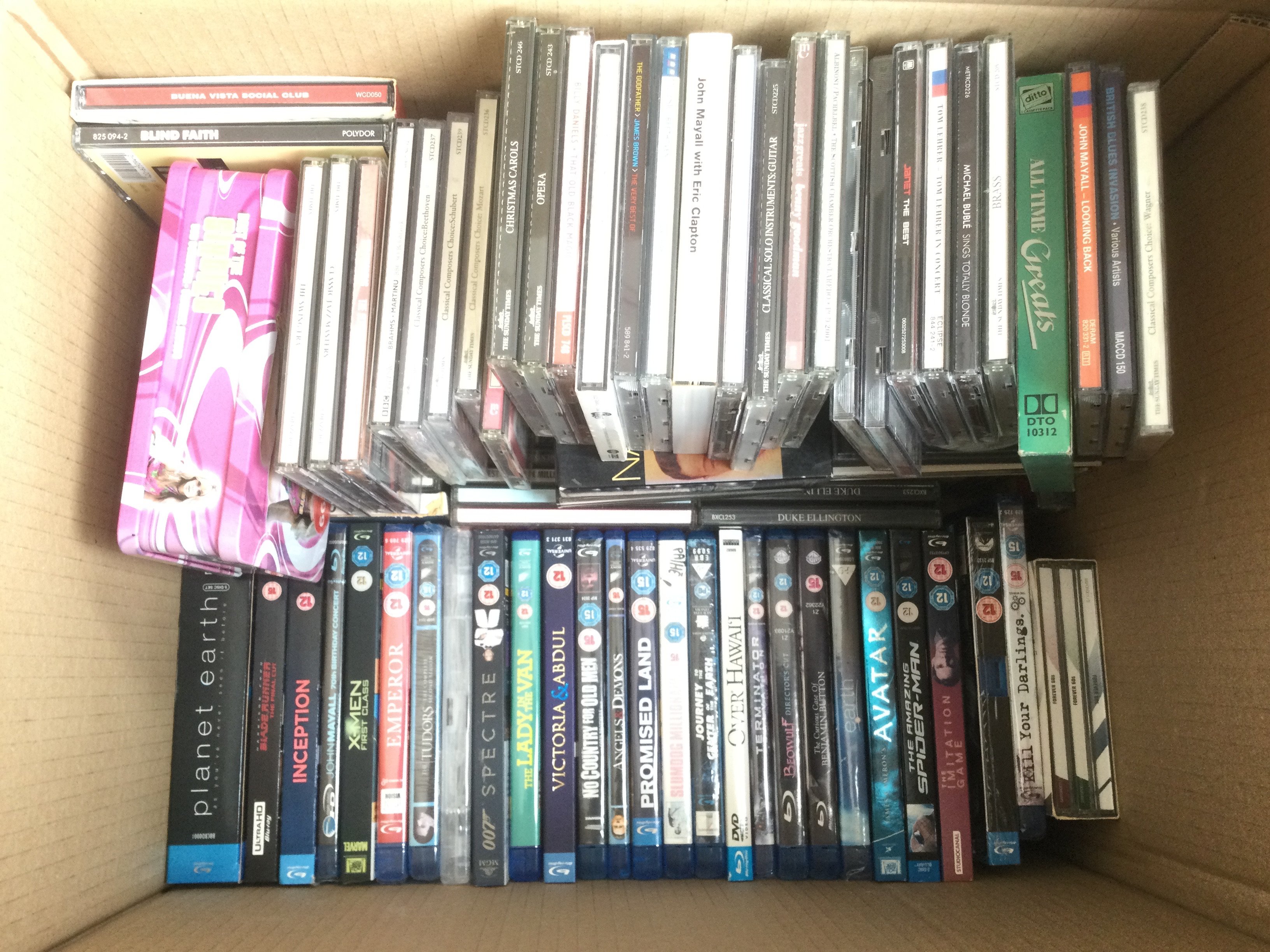 Four boxes of BluRays, DVDs and CDs.
