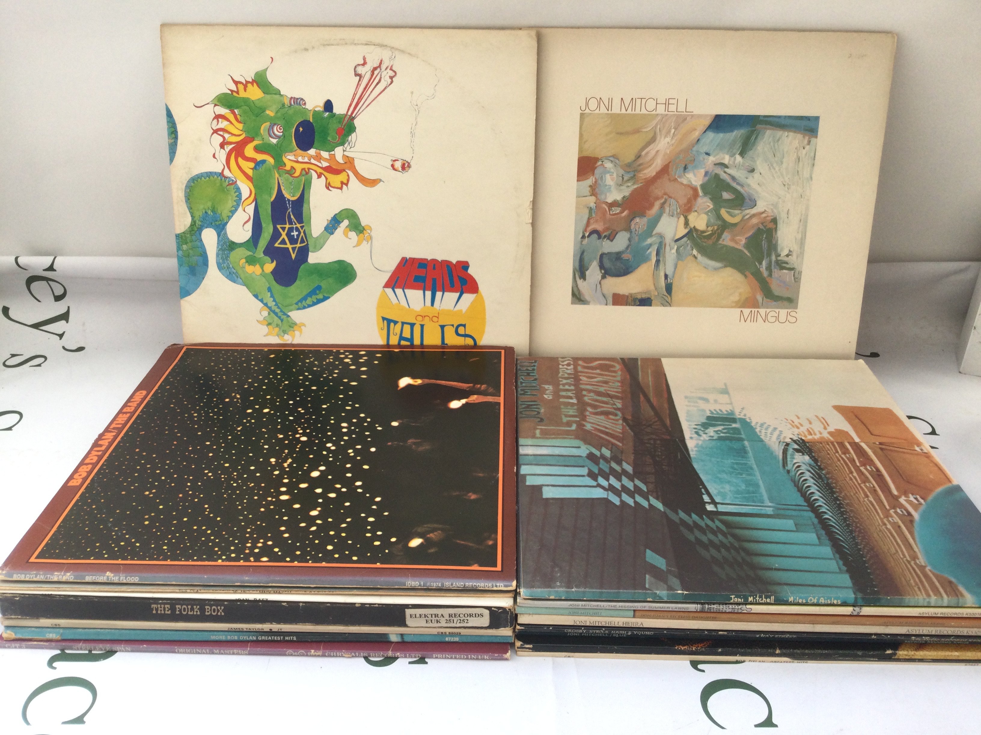 Two bags containing a collection of folk rock LPs by various artists including Bob Dylan, Joni Mitchell, CSNY and others.