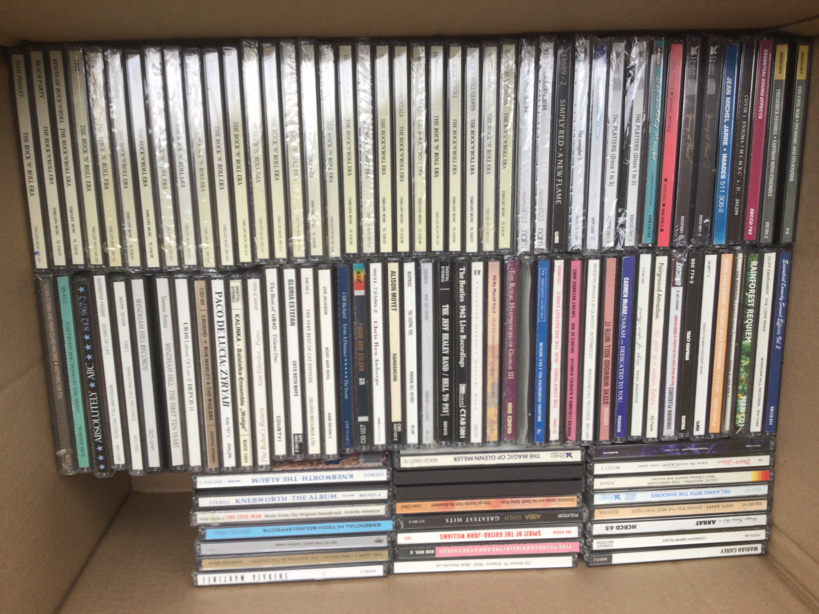 Two boxes of CDs by various artists including The Beatles, Oasis, Adele and many more.