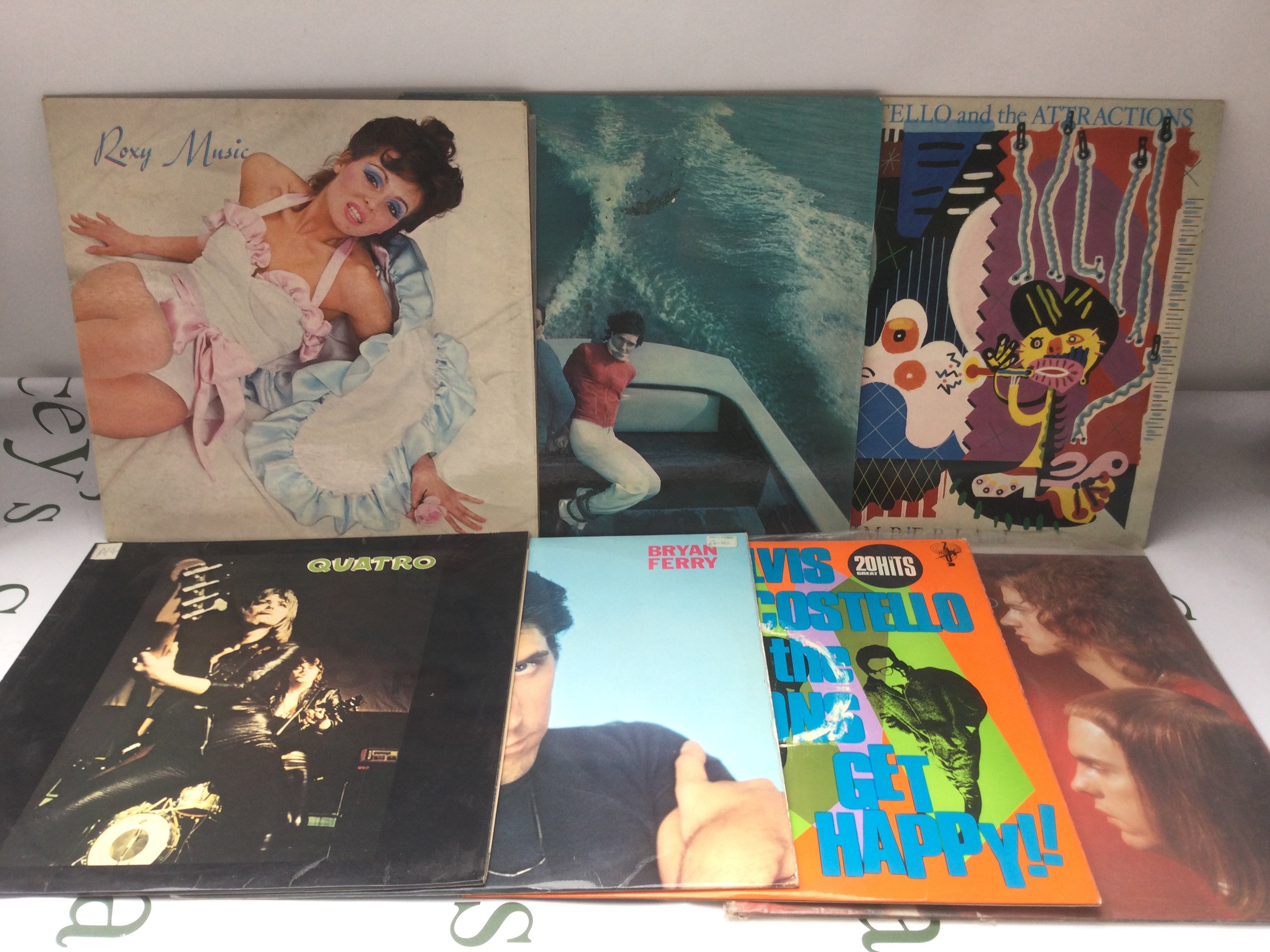 Fourteen rock and pop LPs by various artists including Roxy Music, Elvis Costello and others.
