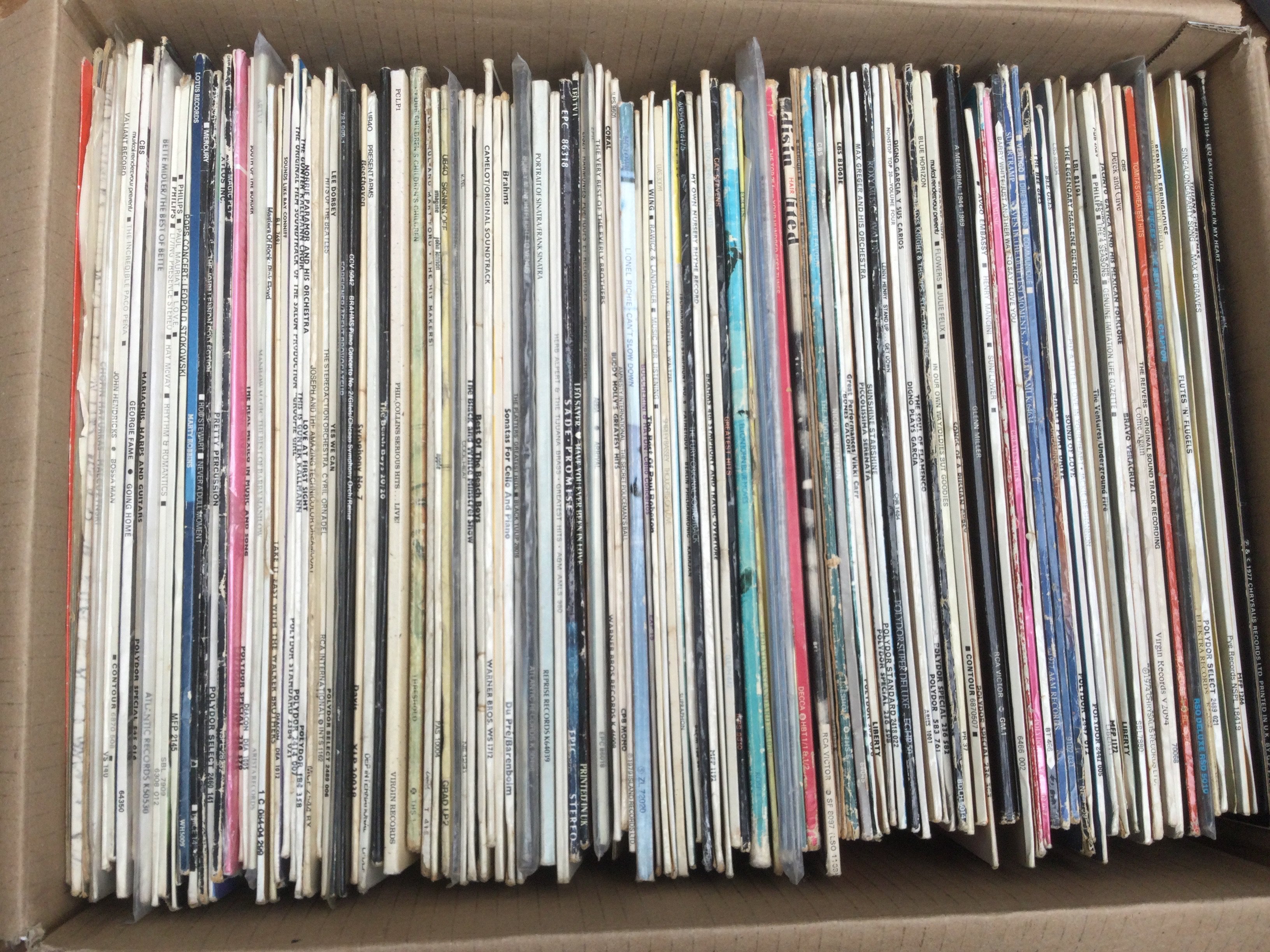A box of LPs by various artists including Jethro Tull, Abba, Eric Clapton and others plus some film soundtracks.