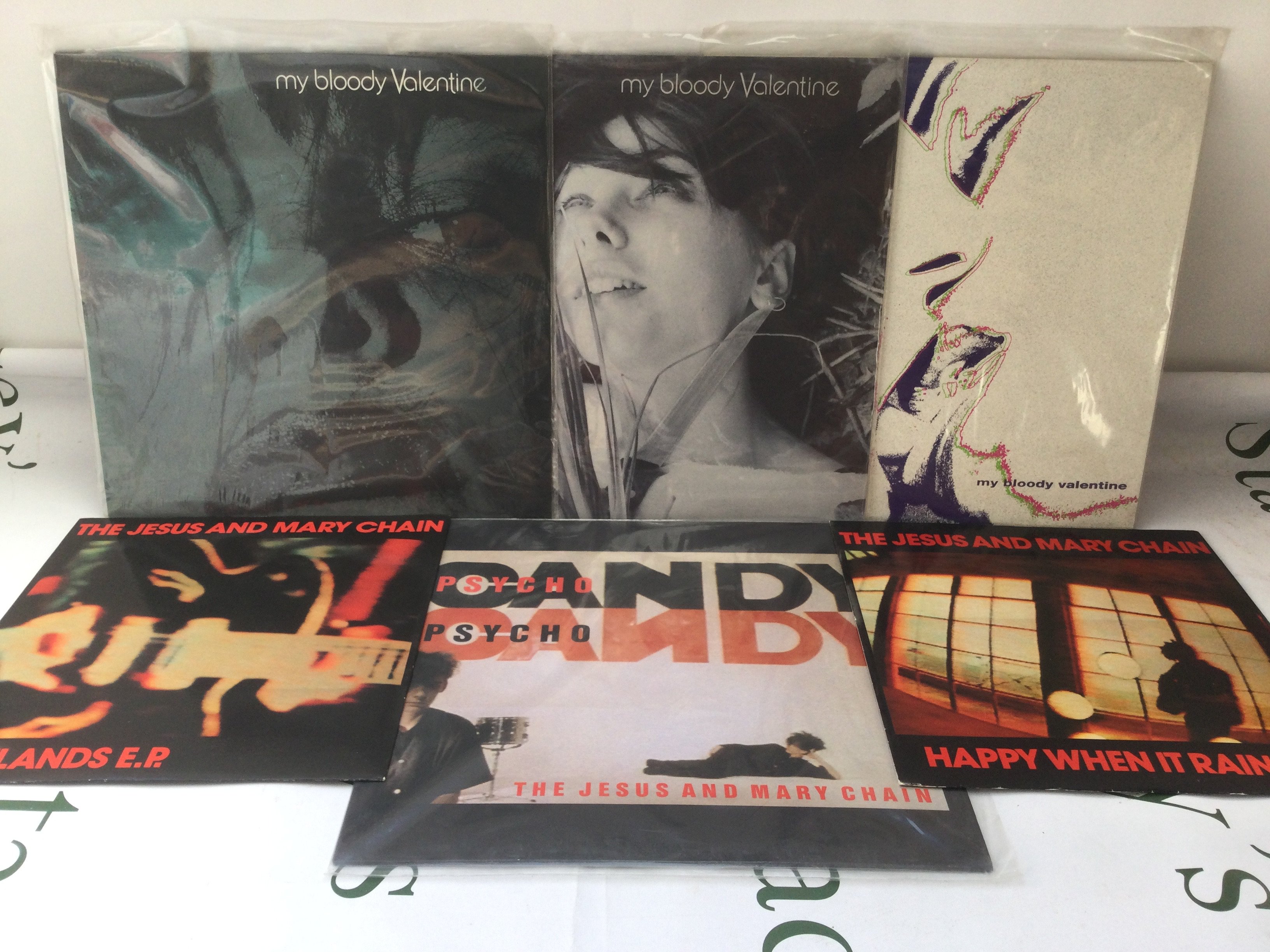Three My Bloody Valentine 12" singles, a Jesus & Mary Chain LP and two 12" singles.