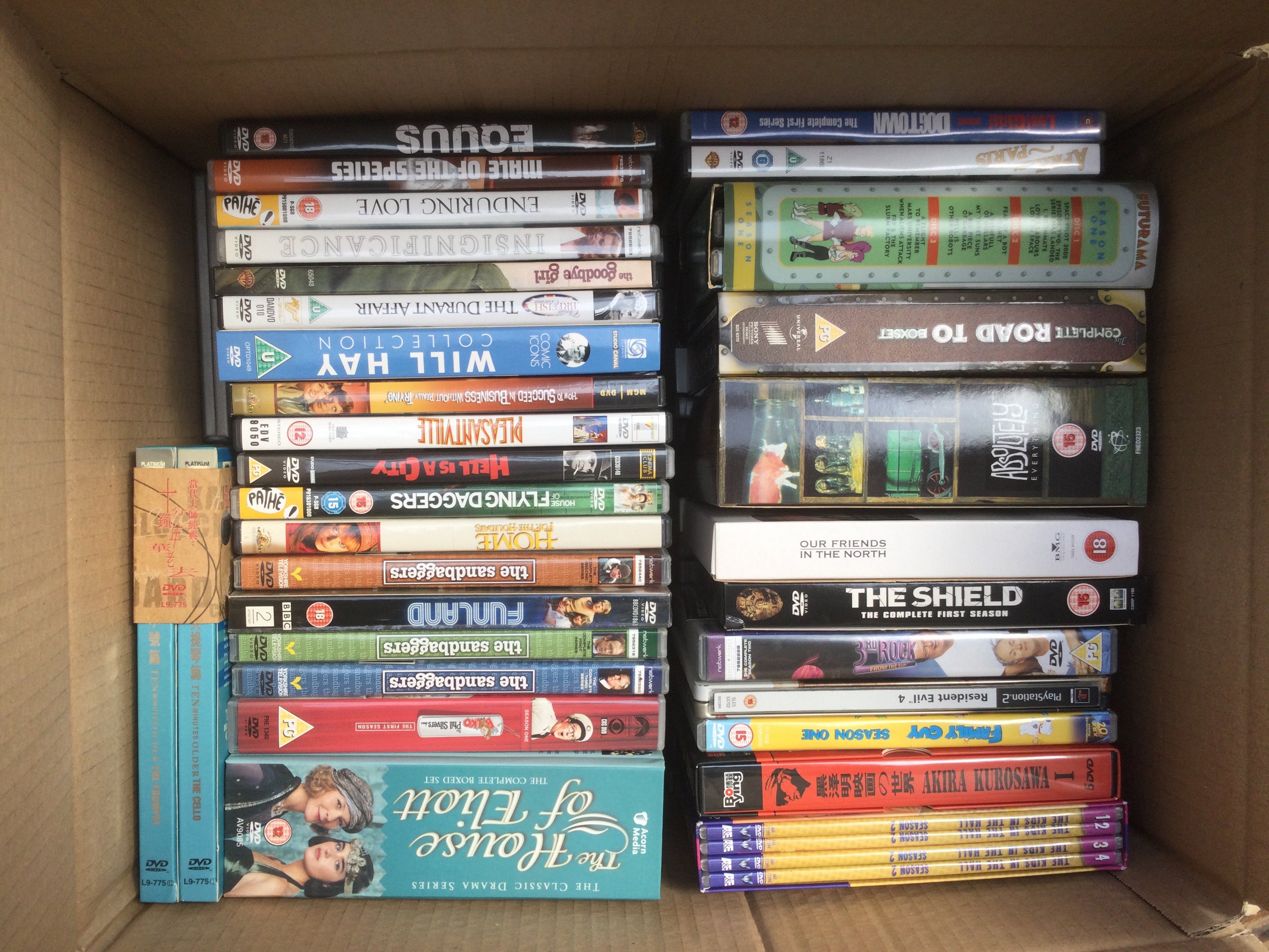Four boxes of DVDs and BluRays including various box sets.