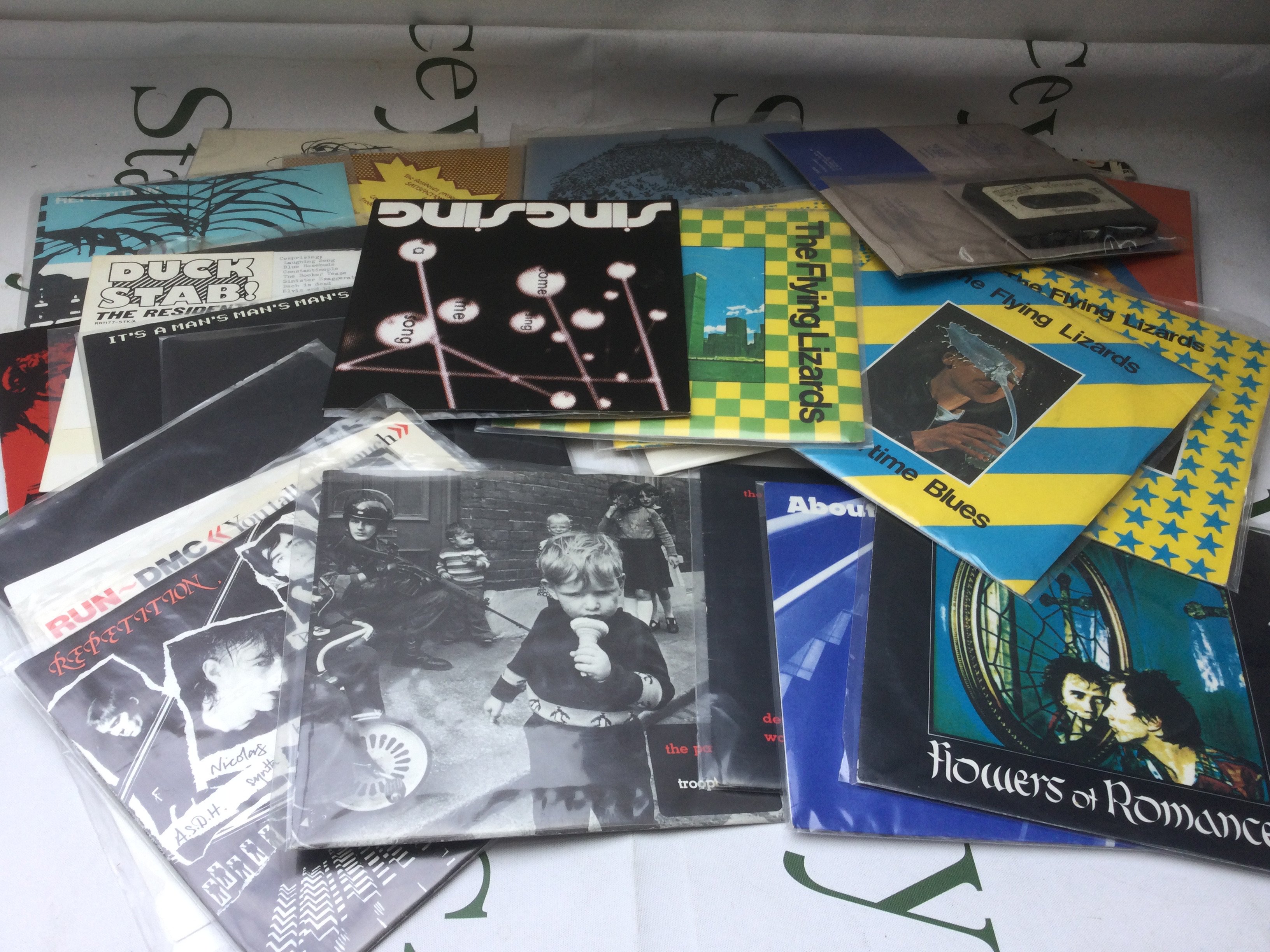 A collection of 7" singles by various artists including PiL, The Residents, The Flying Lizards and others.