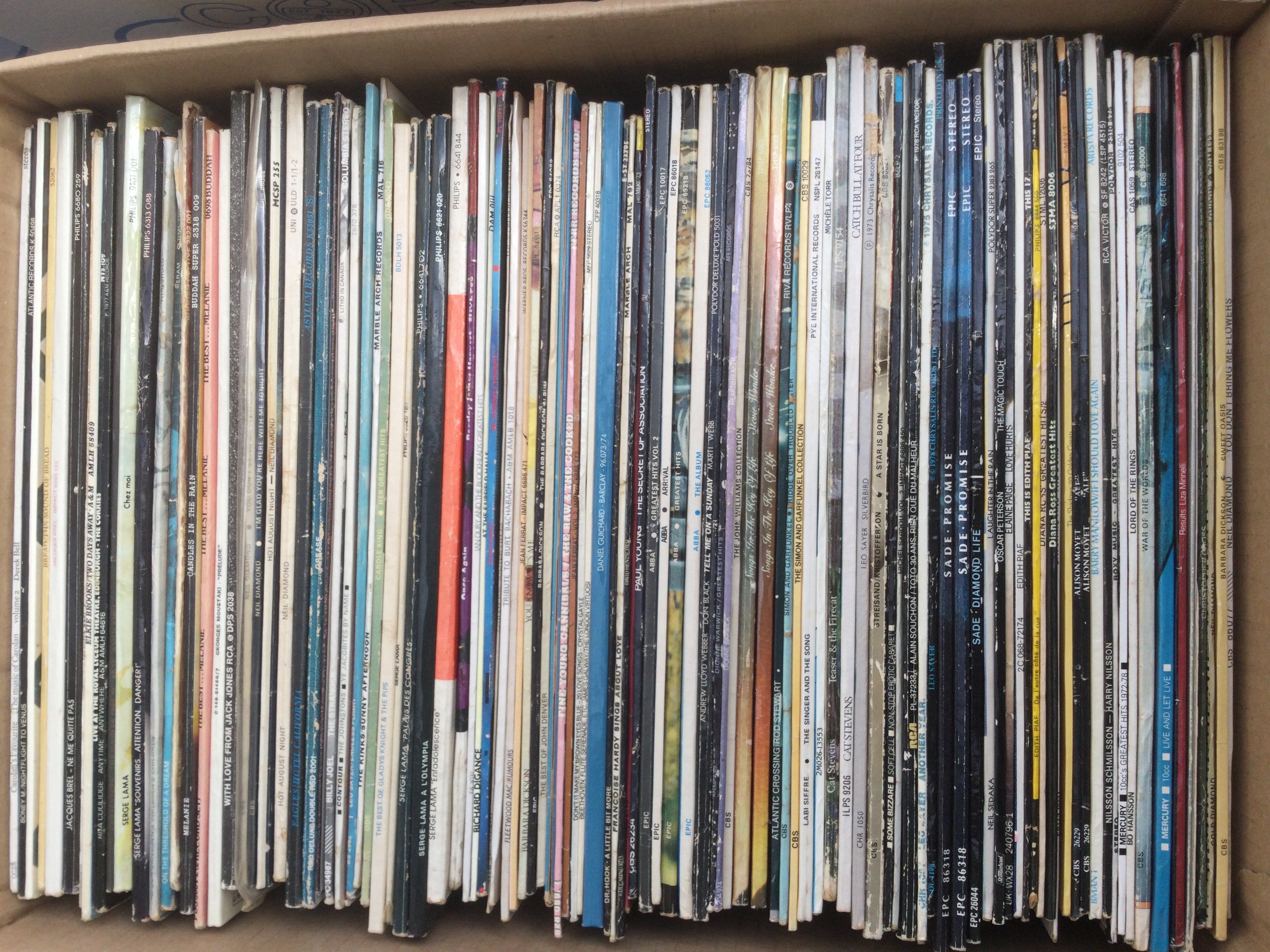 A box and a bag of LPs by various artists including Abba, Elton John, ELO and many more.