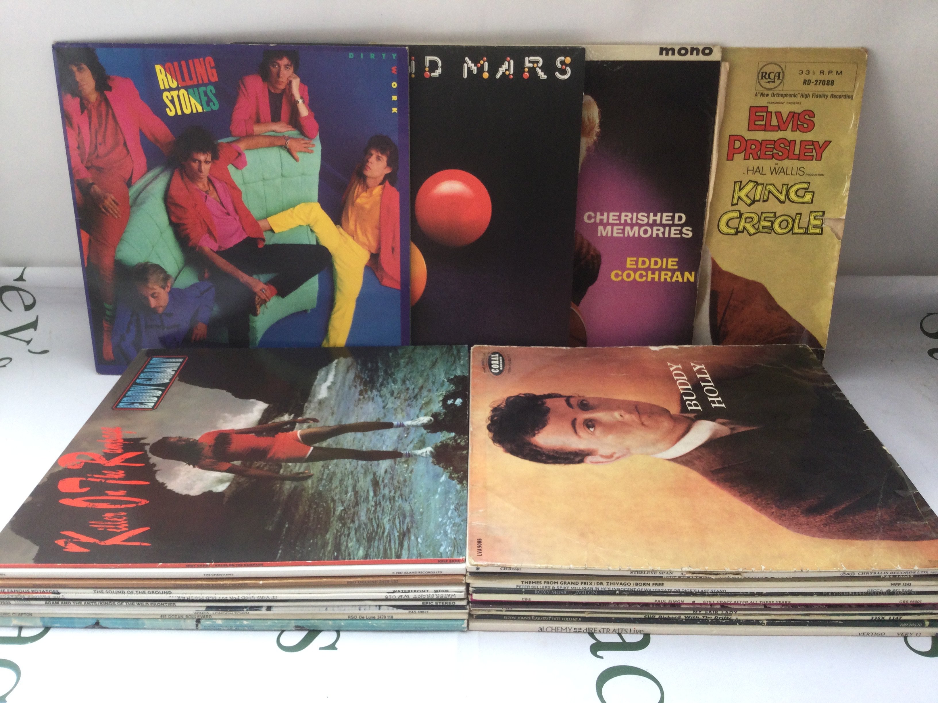 A box and bag of LPs, EPs and 7" singles by various artists including Elvis Presley, Eddie Cochran, The Beatles and many more.