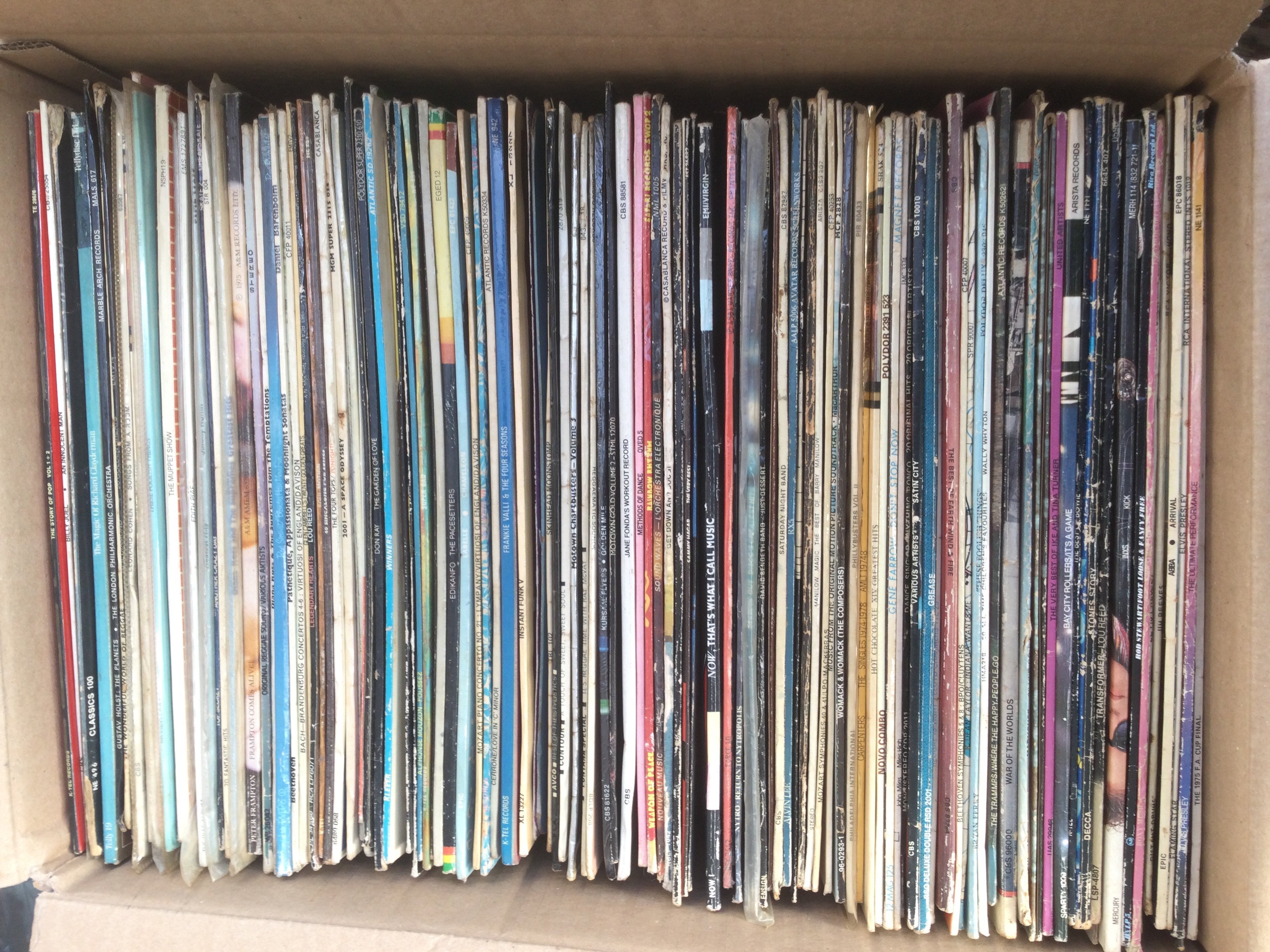 A box of LPs and 12" singles by various artists including Elvis Presley, Lou Reed, INXS and many more.