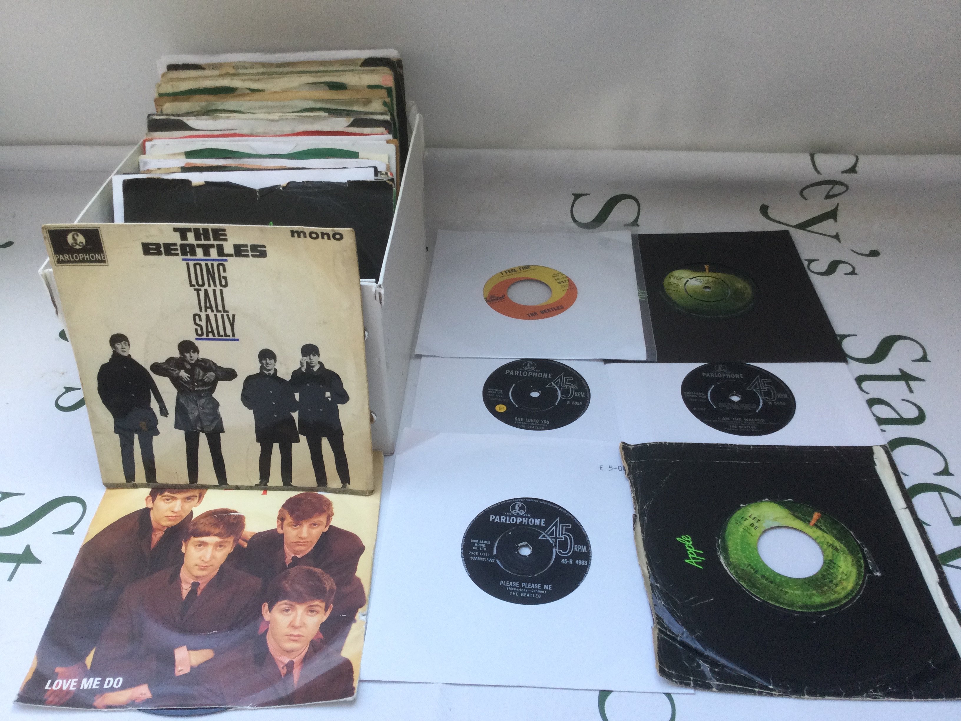 A collection of Beatles 7" singles and EPs including a US pressing of I Feel Fine b/w She's A Woman.