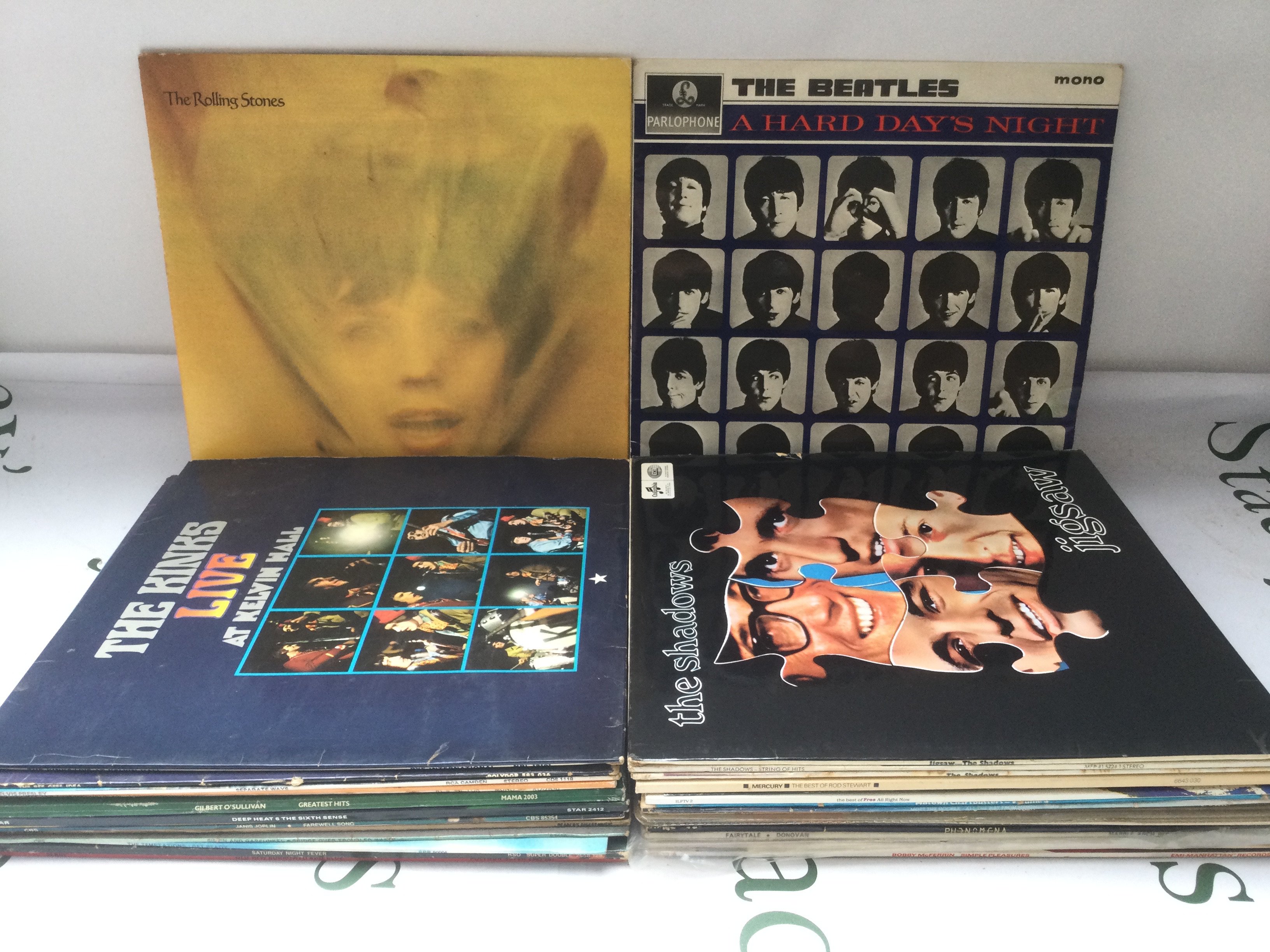 A collection of LPs by various artists including The Beatles, Rolling Stones, The Kinks and others.