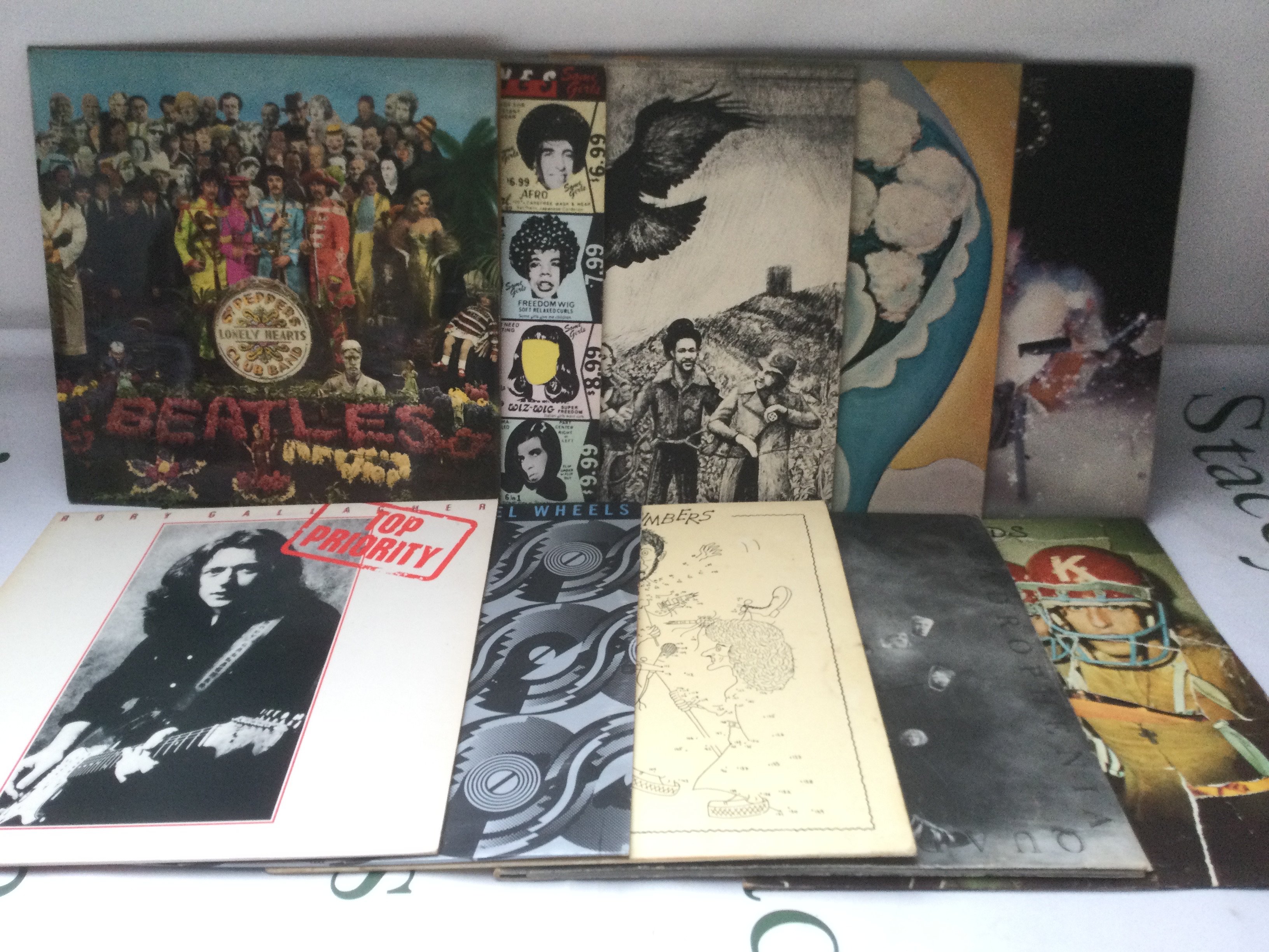Ten rock LPs by various artists including The Beatles, The Who, Rolling Stones and others.
