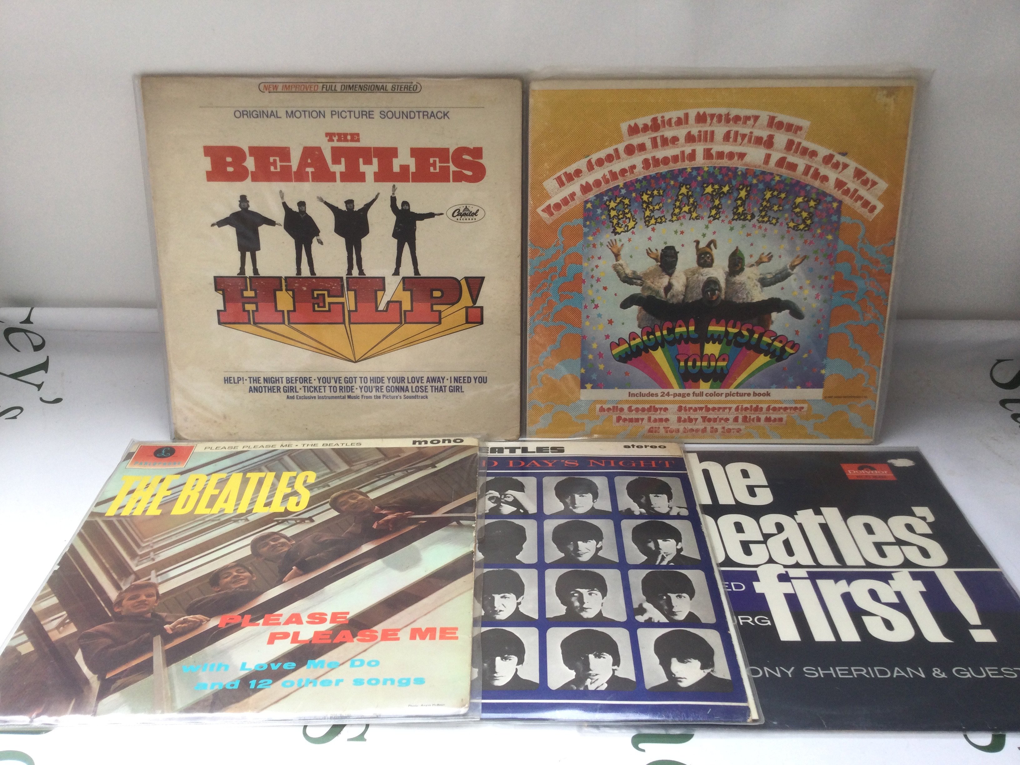 Five Beatles LPs including two US pressings of Help! and Magical Mystery Tour.