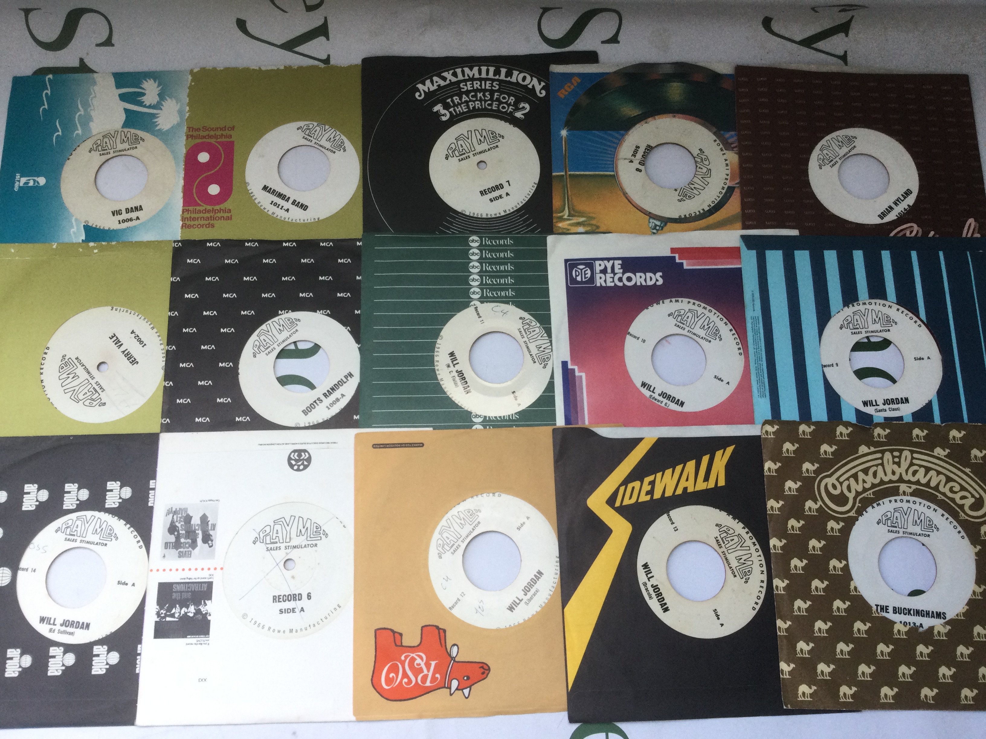 15 red vinyl Play Me Sales Stimulator 7" records. These were made to be used in Rowe/AMI jukeboxes to draw attention to the jukebox to stimulate sales. There was a mechanical device that was added to the jukebox and the record was placed in a specific slot and if the jukebox sat idle not playing any records the device would select this record and play it.