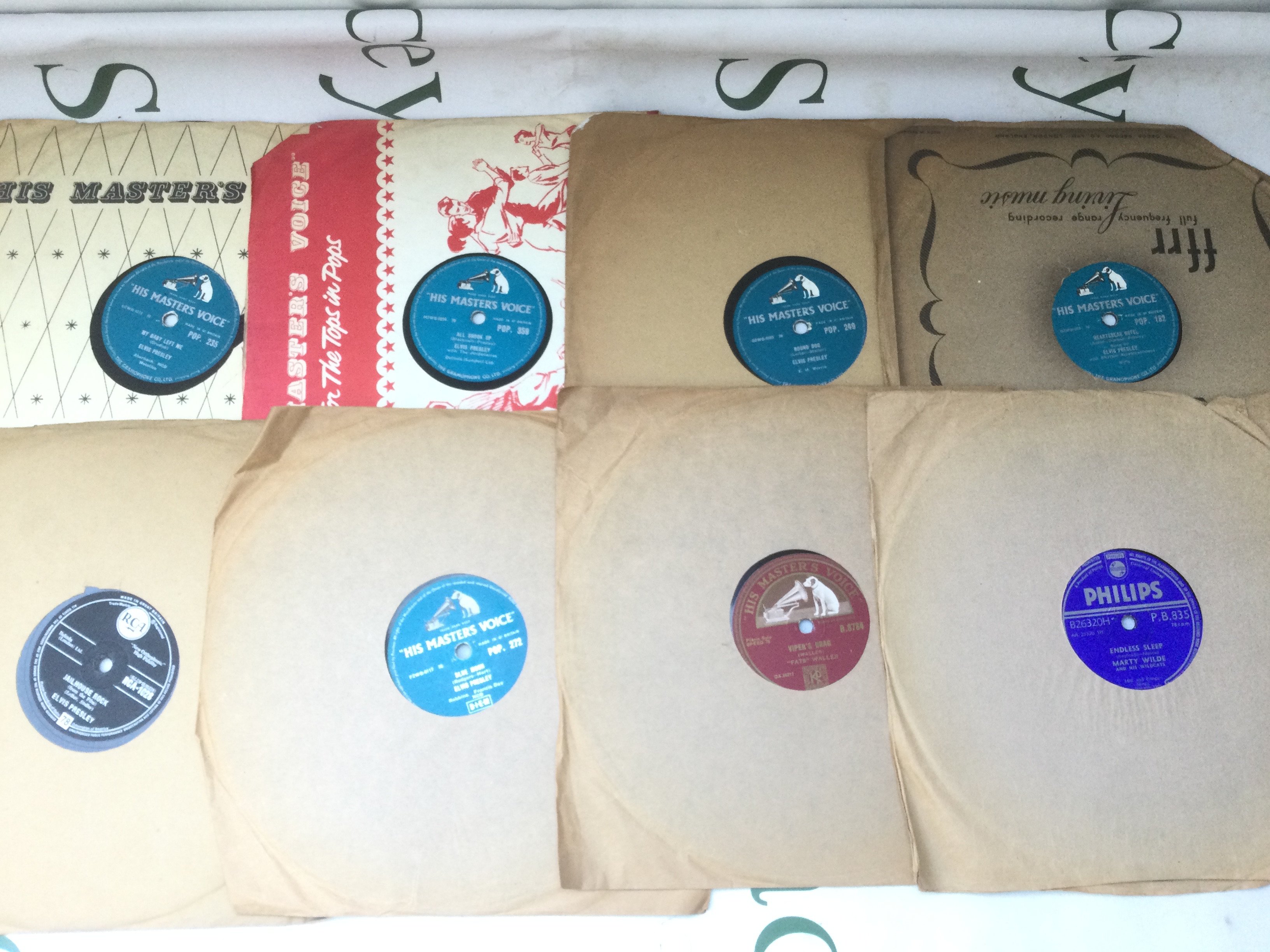 A box of 78s including Elvis Presley, Marty Wilde and others.
