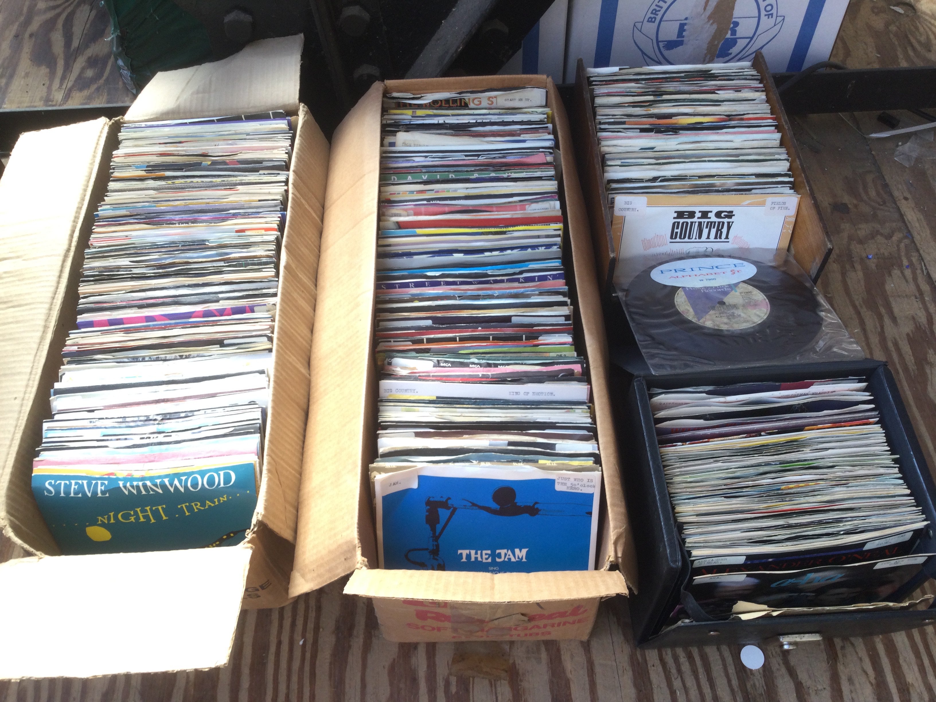 Six small boxes and a record case of 7" singles including some picture discs and promos. Various artists including The Jam, Prince, David Bowie and many more.