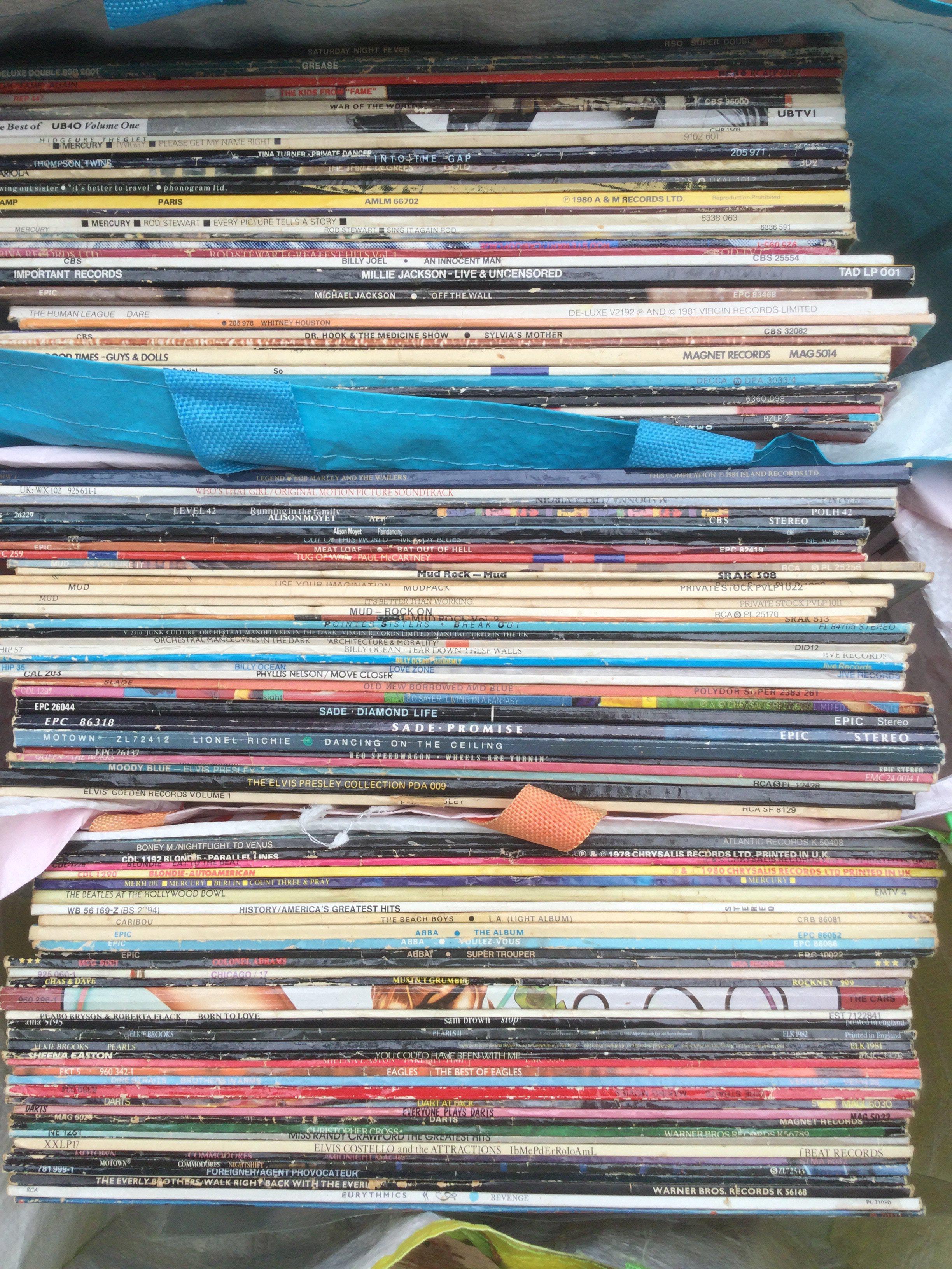 Three bags of LPs and 12" singles by various artists including Bruce Springsteen, UB40, Blondie and others.