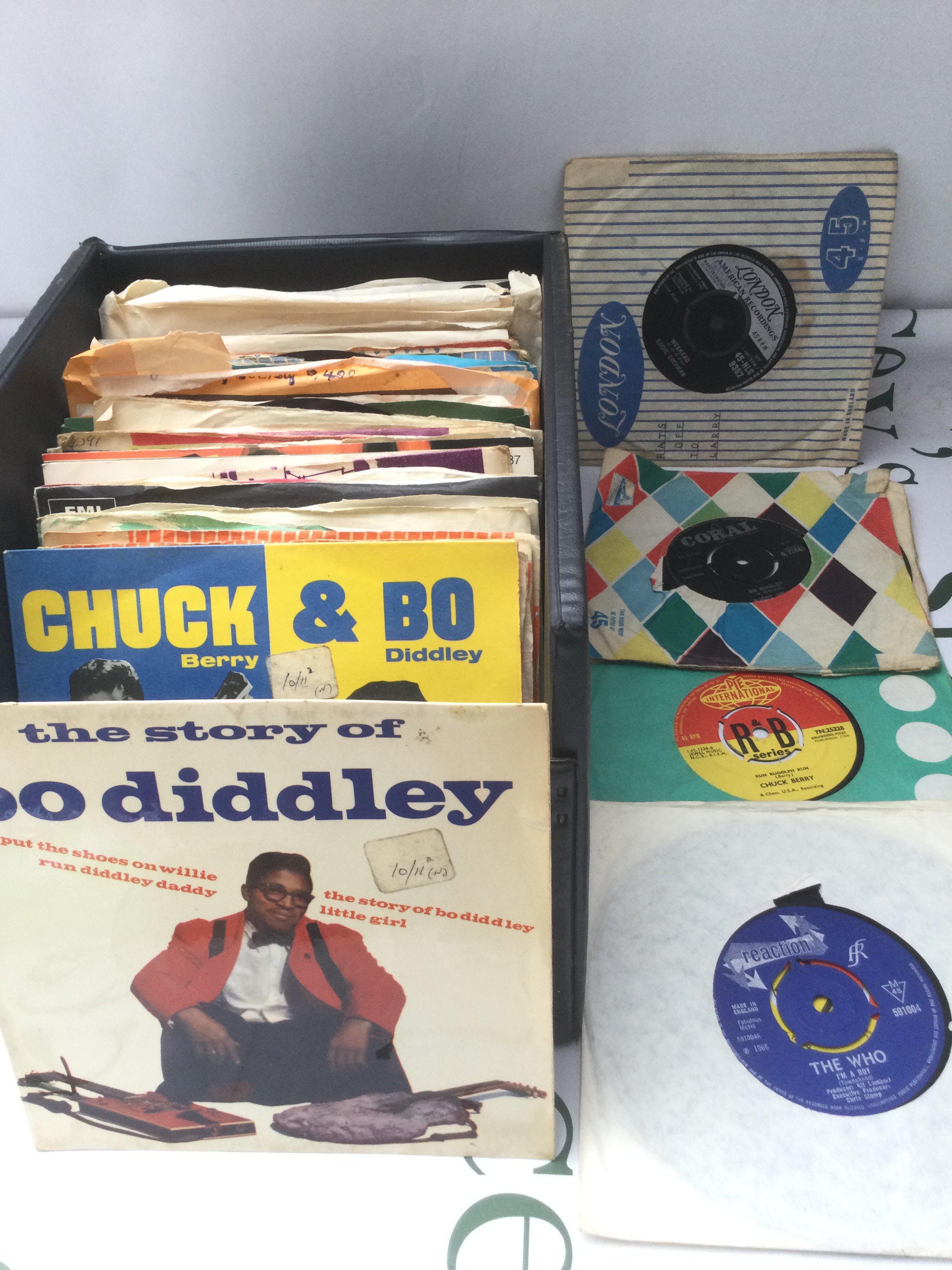 A record case of 7" singles and EPs by various artists including The Who, Bo Diddley, The Animals and others.