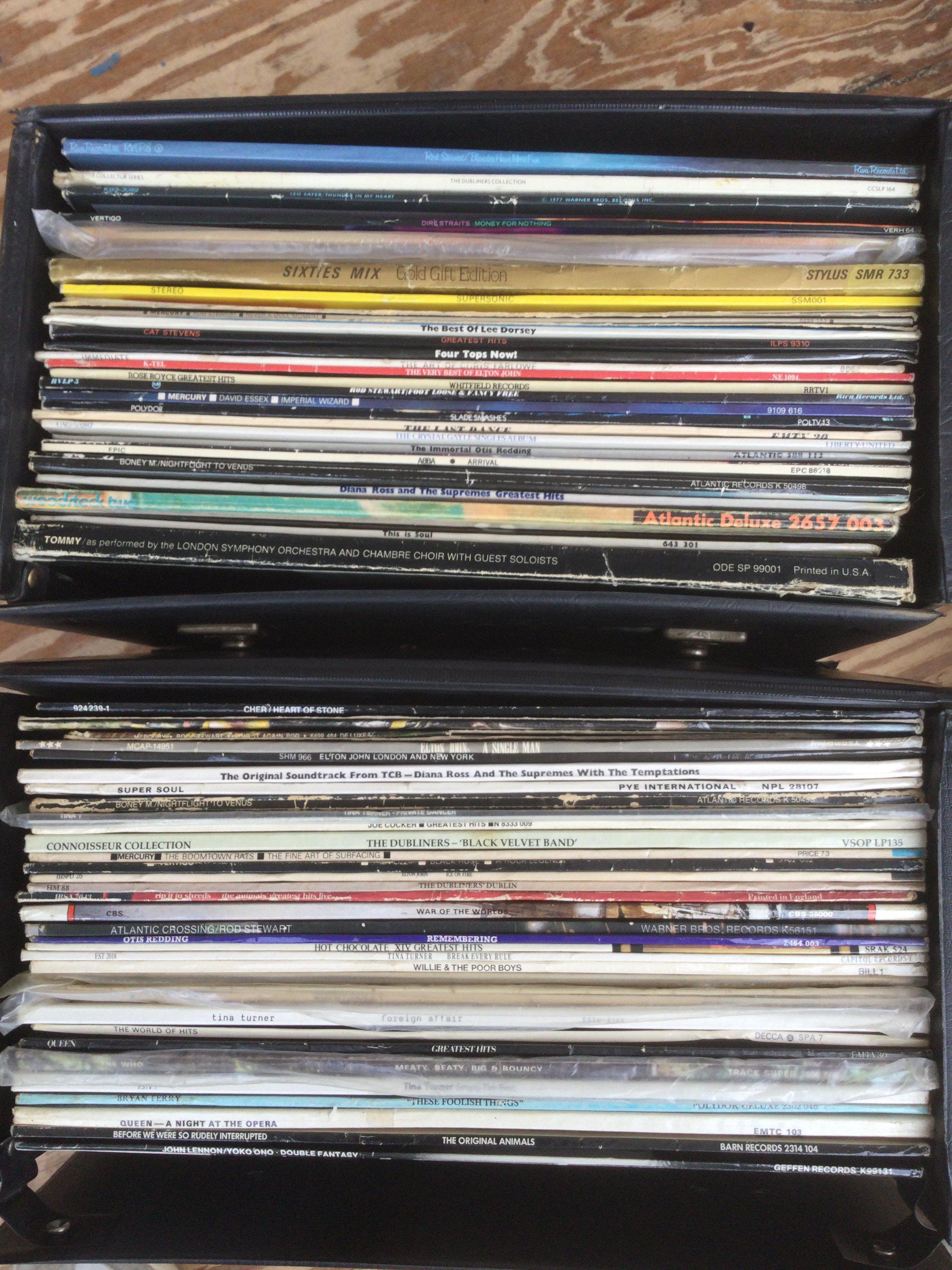 Two record cases of LPs by various artists including Queen, John Lennon, The Who and others.