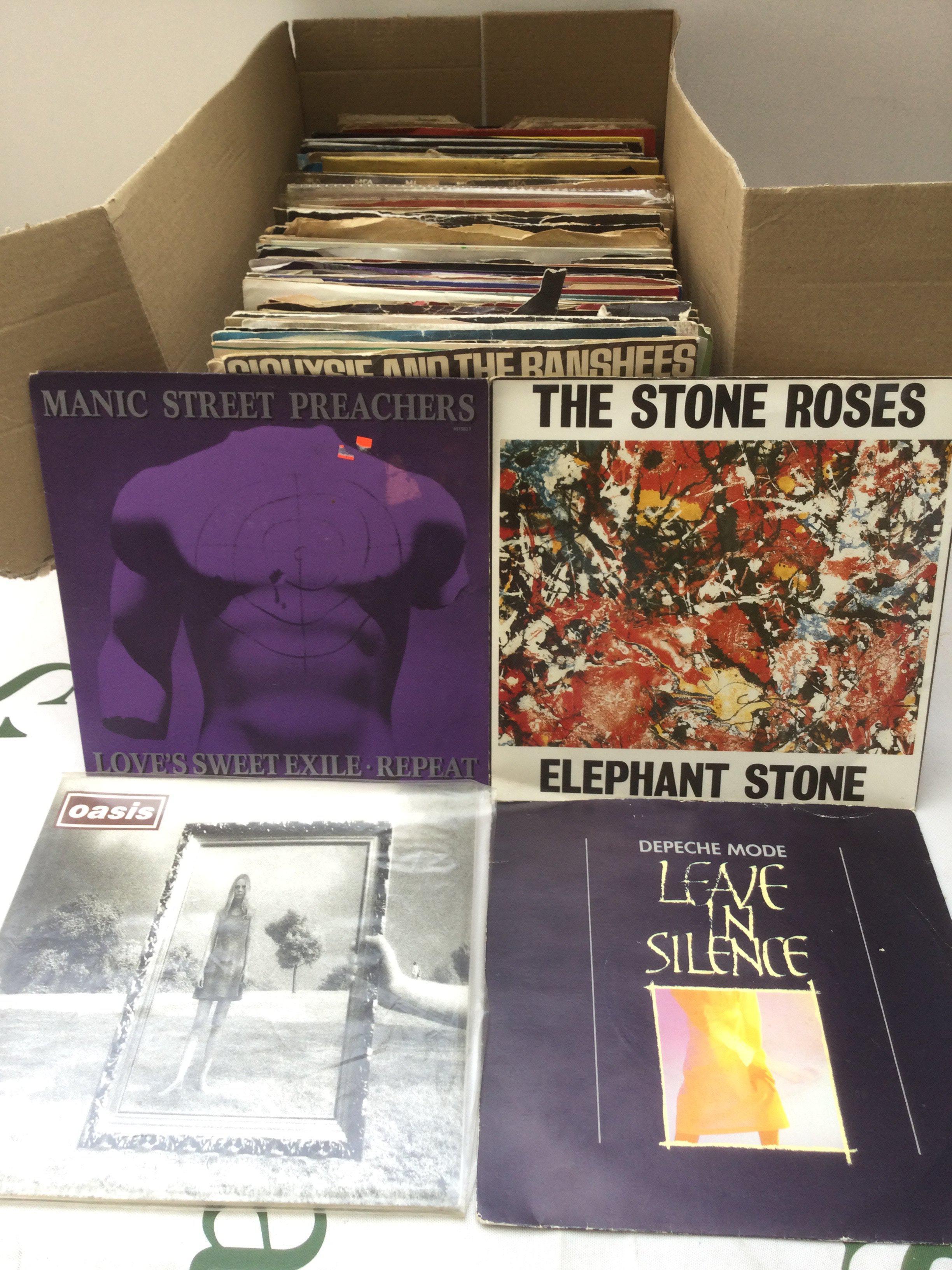 A collection of 7" singles by various artists including Oasis, The Stone Roses, Depeche Mode and others.