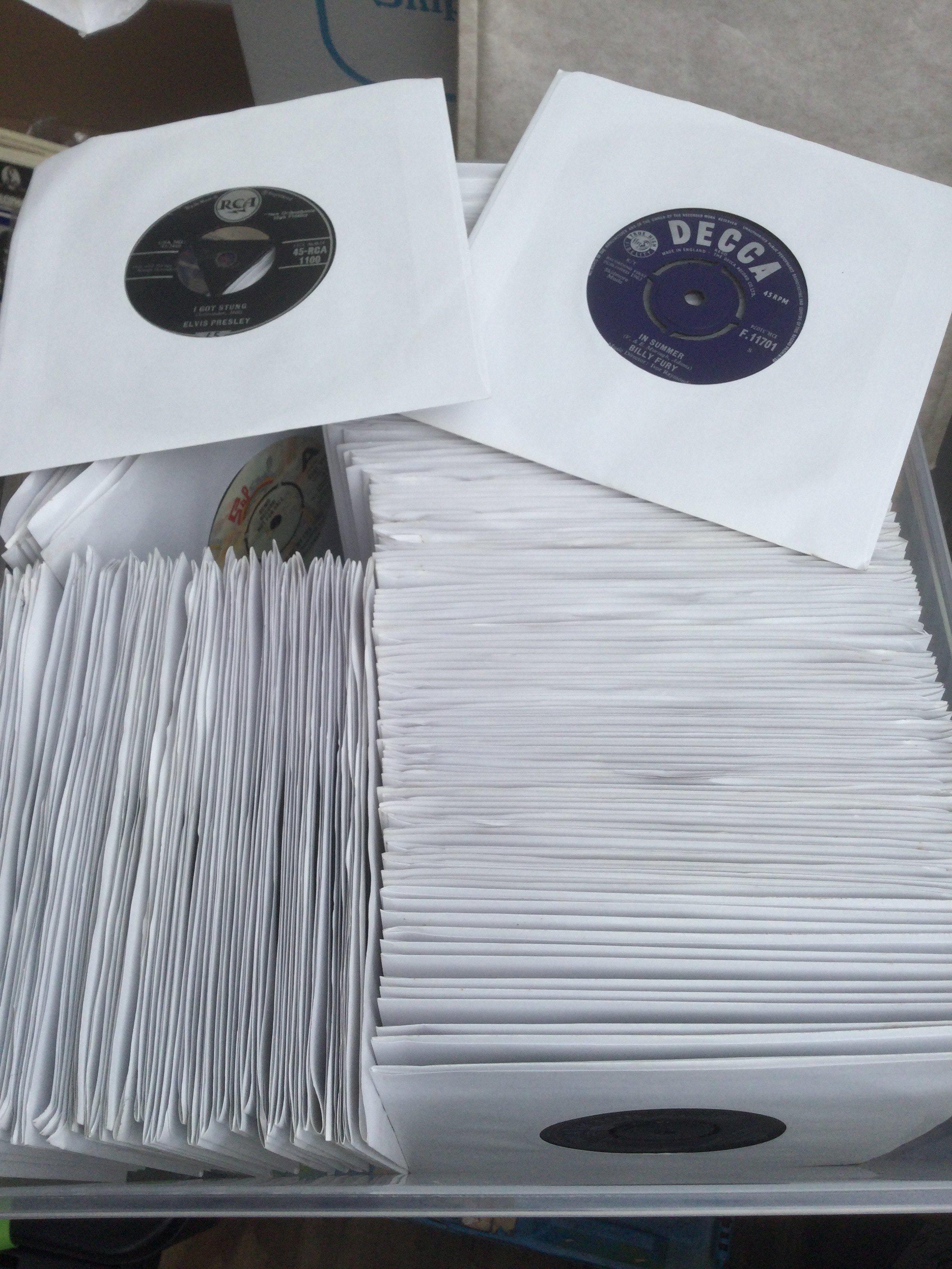 Two boxes of 7" singles by various artists including The Beatles, Elvis Presley, Deep Purple and many more.