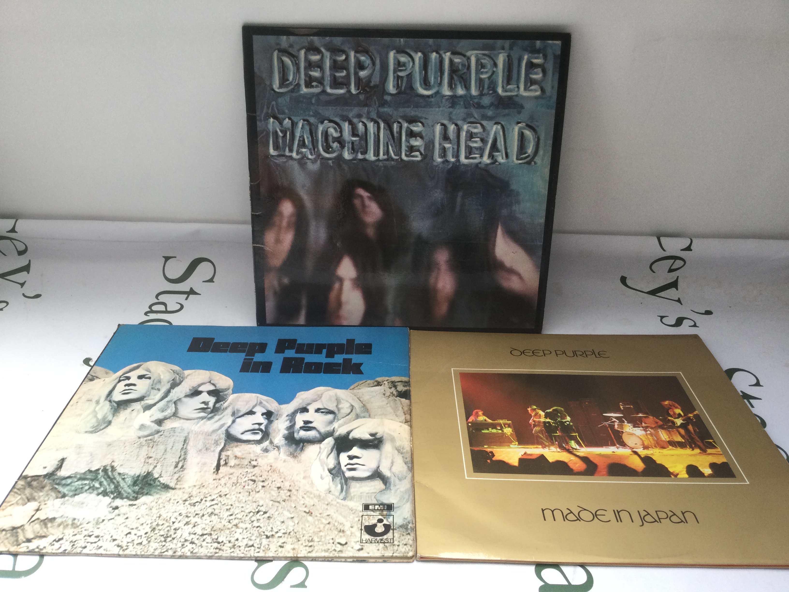 Three Deep Purple LPs comprising Machine Head (with poster), Made In Japan and In Rock.