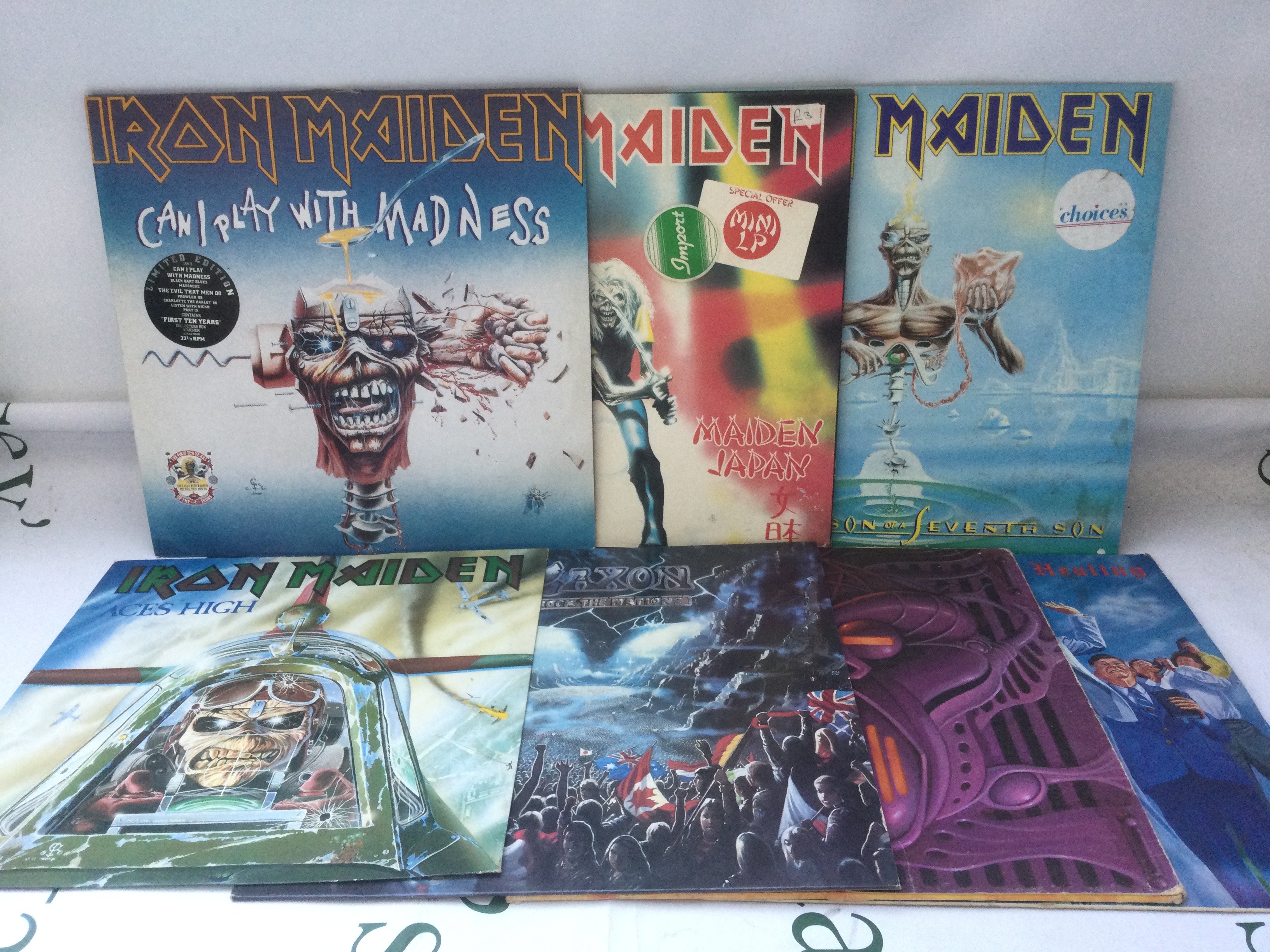 Seven heavy rock LPs and 12" singles by Iron Maiden, Saxon and others.